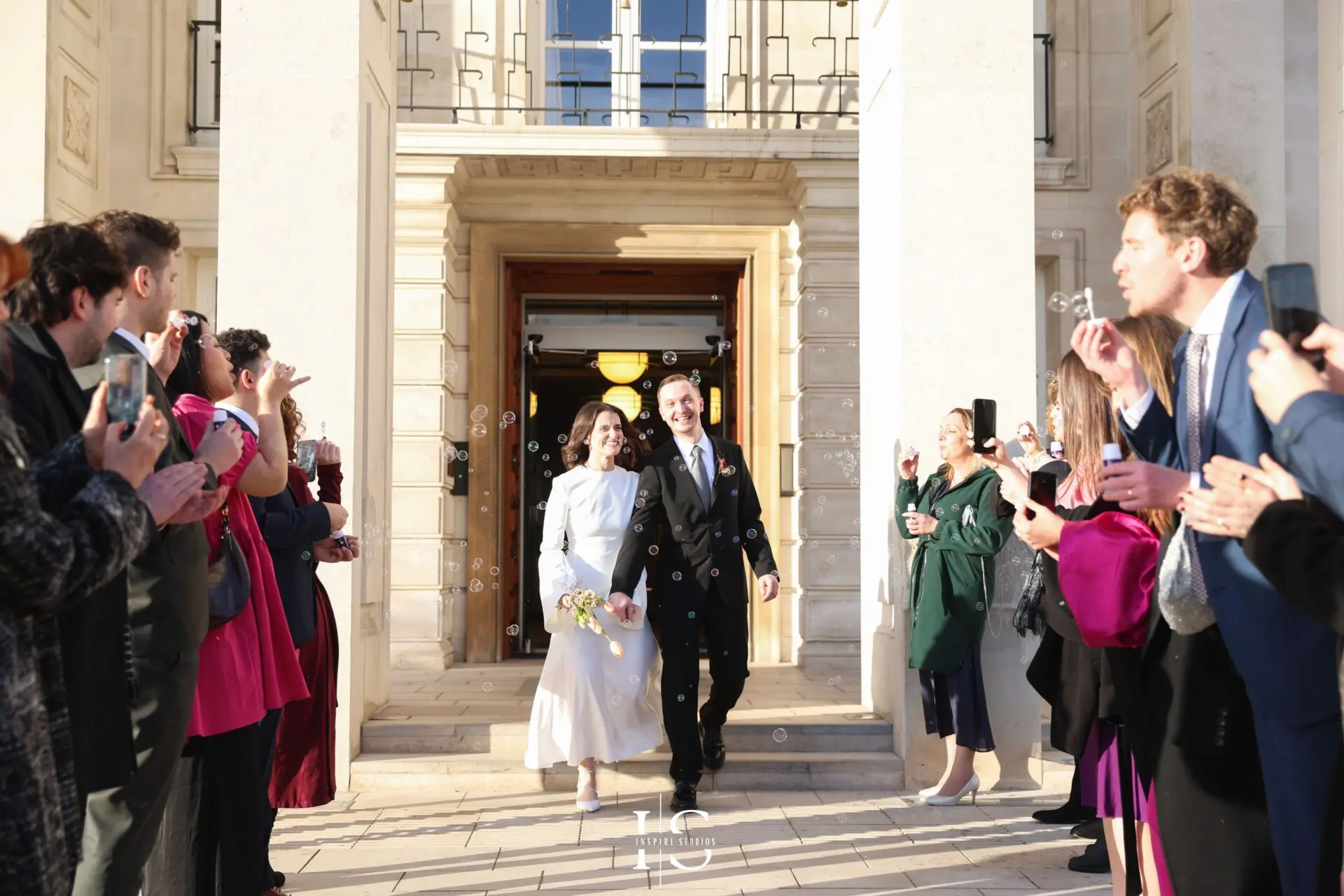 Emotional registry wedding exit with clapping guests at Walthamstow