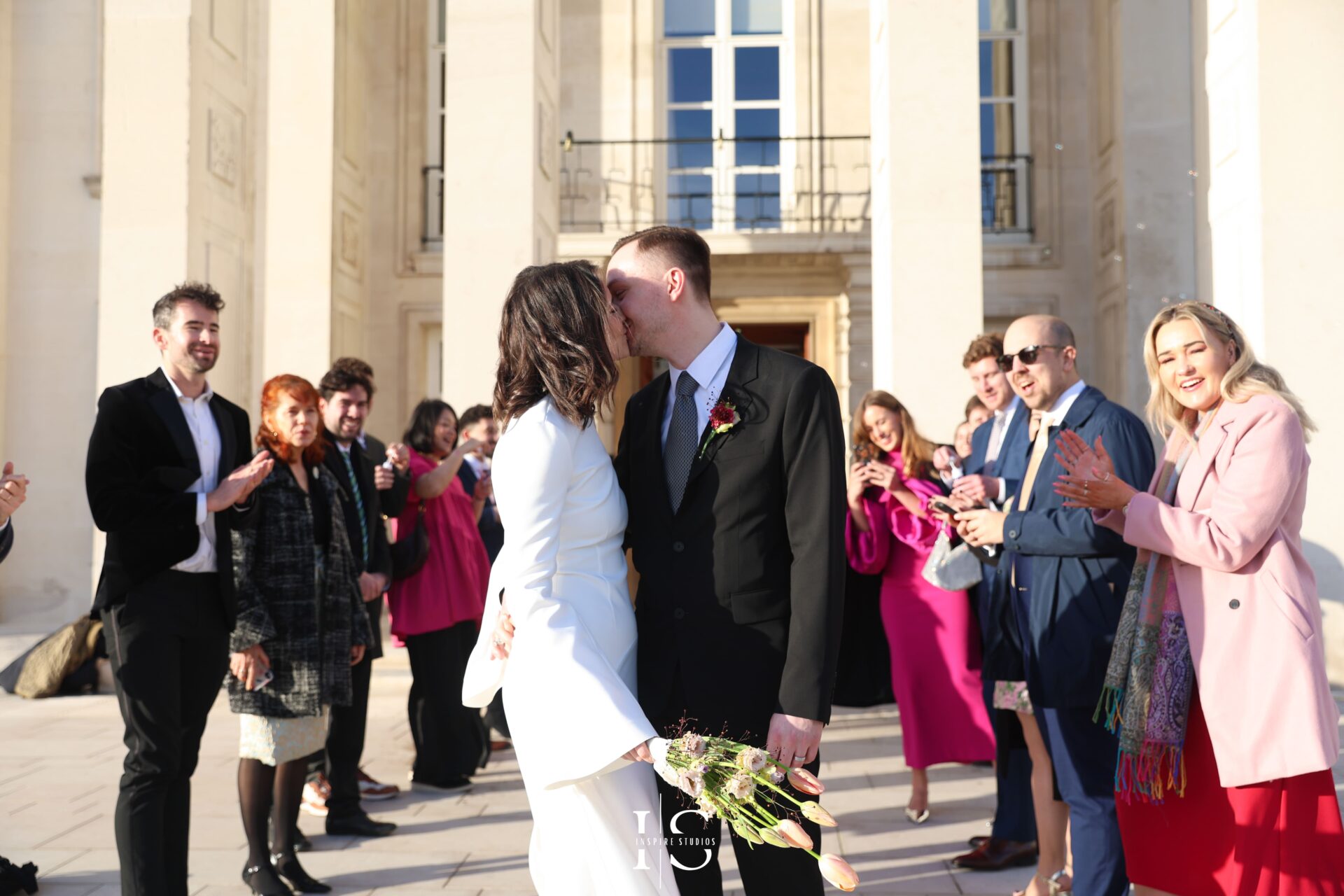 Bride and groom greeted with applause by guests after civil ceremony