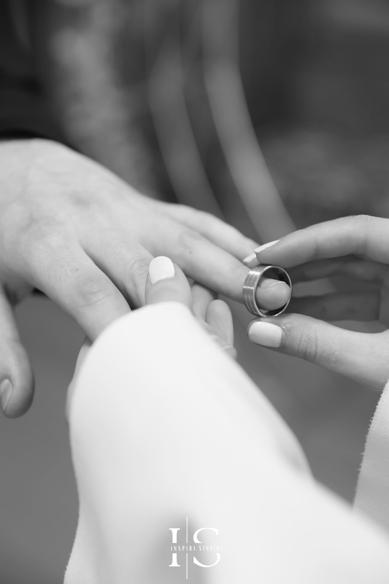 Bride placing ring on groom’s finger during London civil wedding