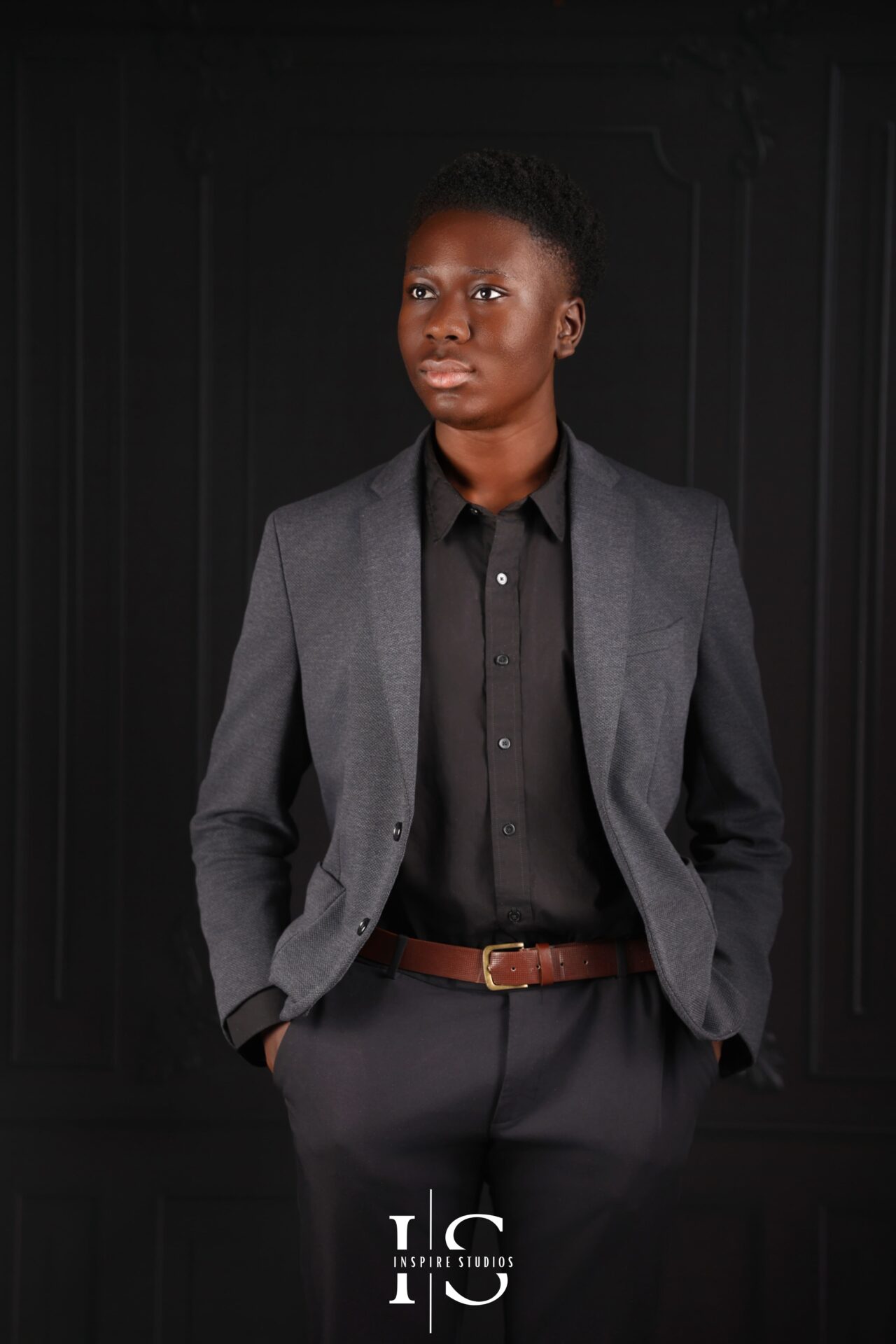 Relaxed seated pose of 18‑year‑old male client leaning forward in studio portrait
