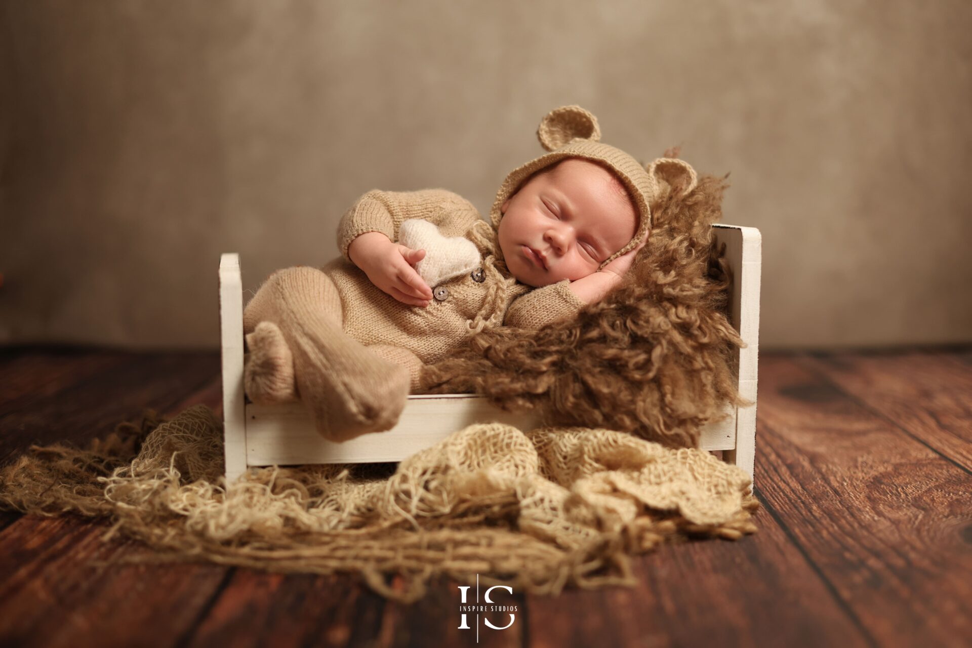 Styled newborn backdrop session with natural wood, pampas, and wheat for a baby boy