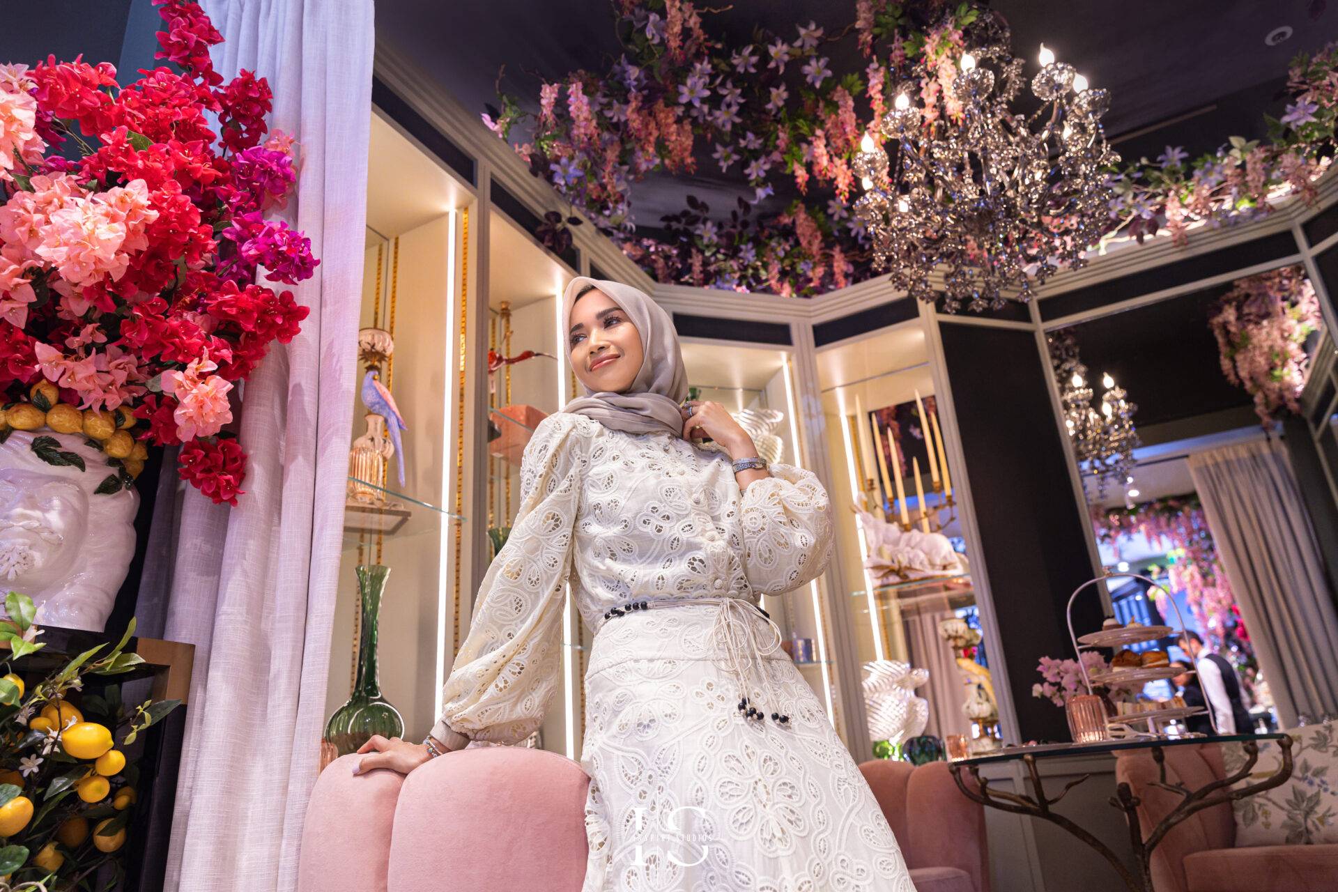 Close-up birthday portrait of Naja with luxury floral background at Neill Strain Mayfair.