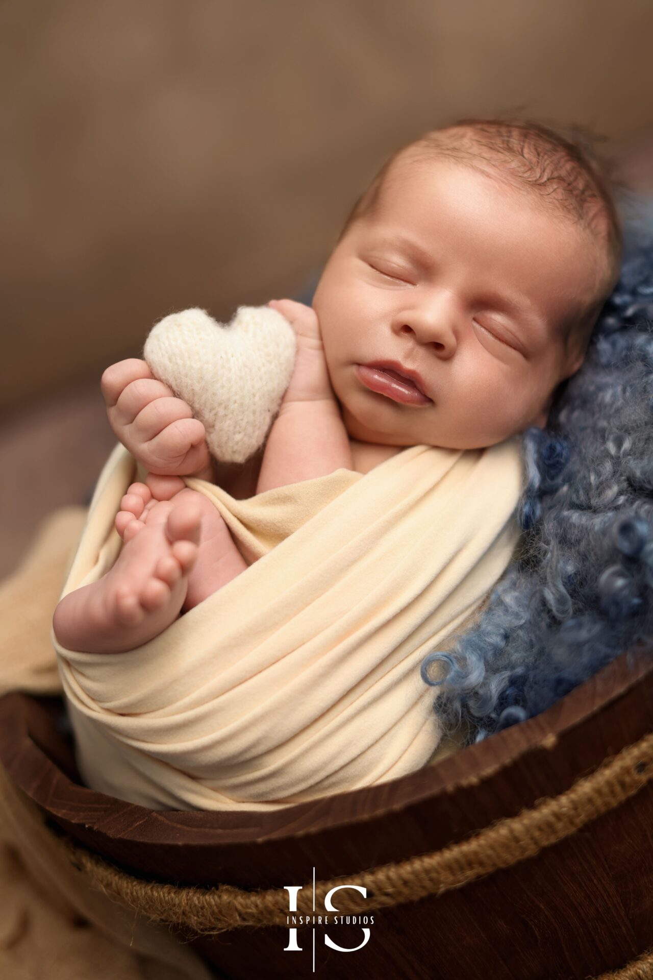 Newborn session in London by female photographer with cozy cream-toned setup