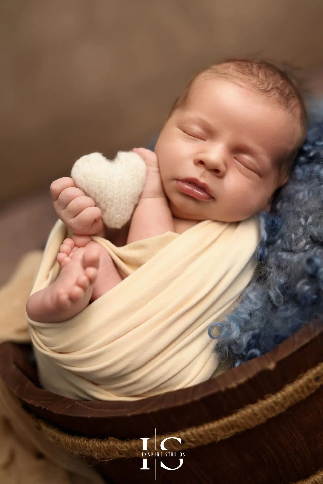 Newborn session in London by female photographer with cozy cream-toned setup