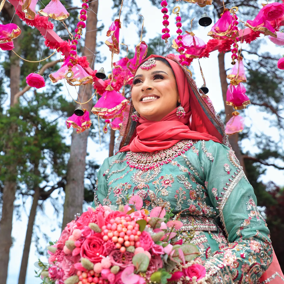 Bride holding a floral bouquet on her Mehndi Henna night, captured by a female wedding photographer in London.