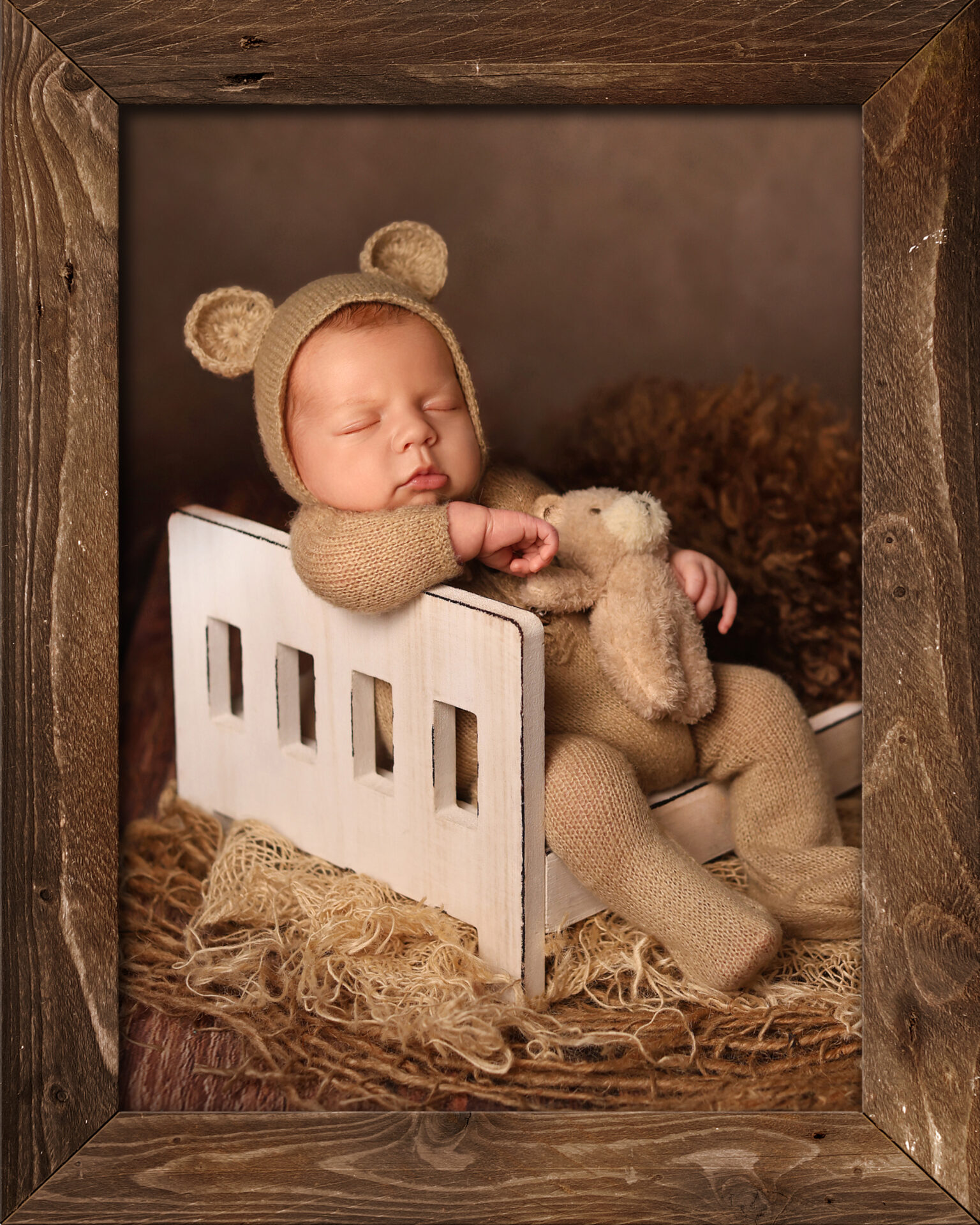 Newborn baby posed on textured studio backdrop with soft props and natural lighting, showcasing modern photography pose ideas