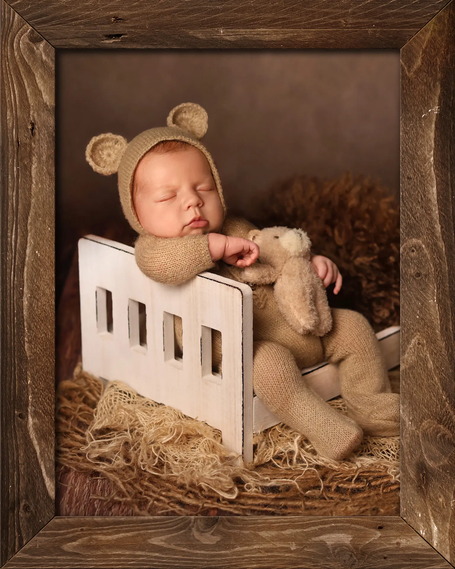 Newborn baby posed on textured studio backdrop with soft props and natural lighting, showcasing modern photography pose ideas