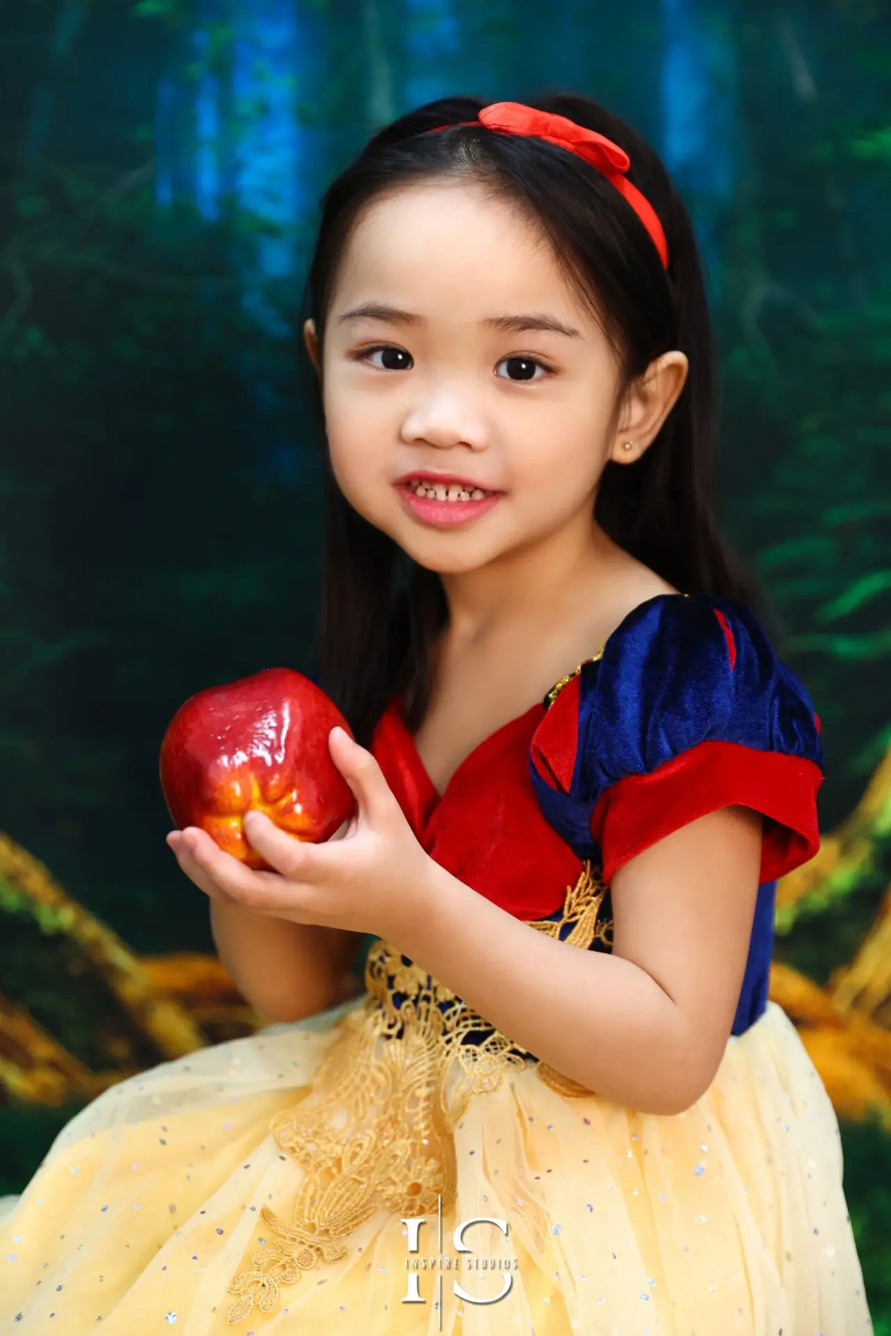 Young girl dressed as Snow White during a children’s studio photoshoot