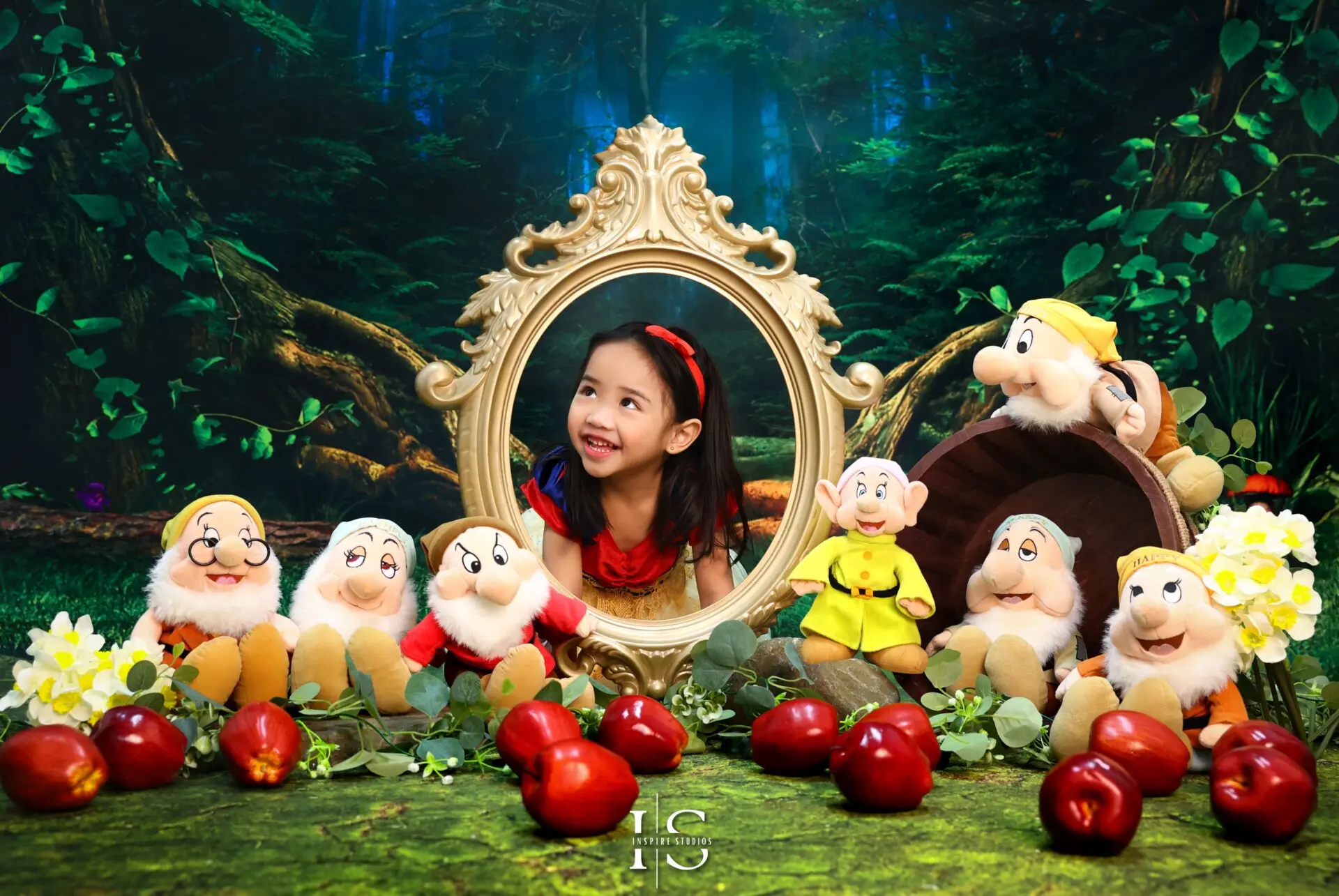 Child dressed as Snow White posing in a fairytale-inspired photography session
