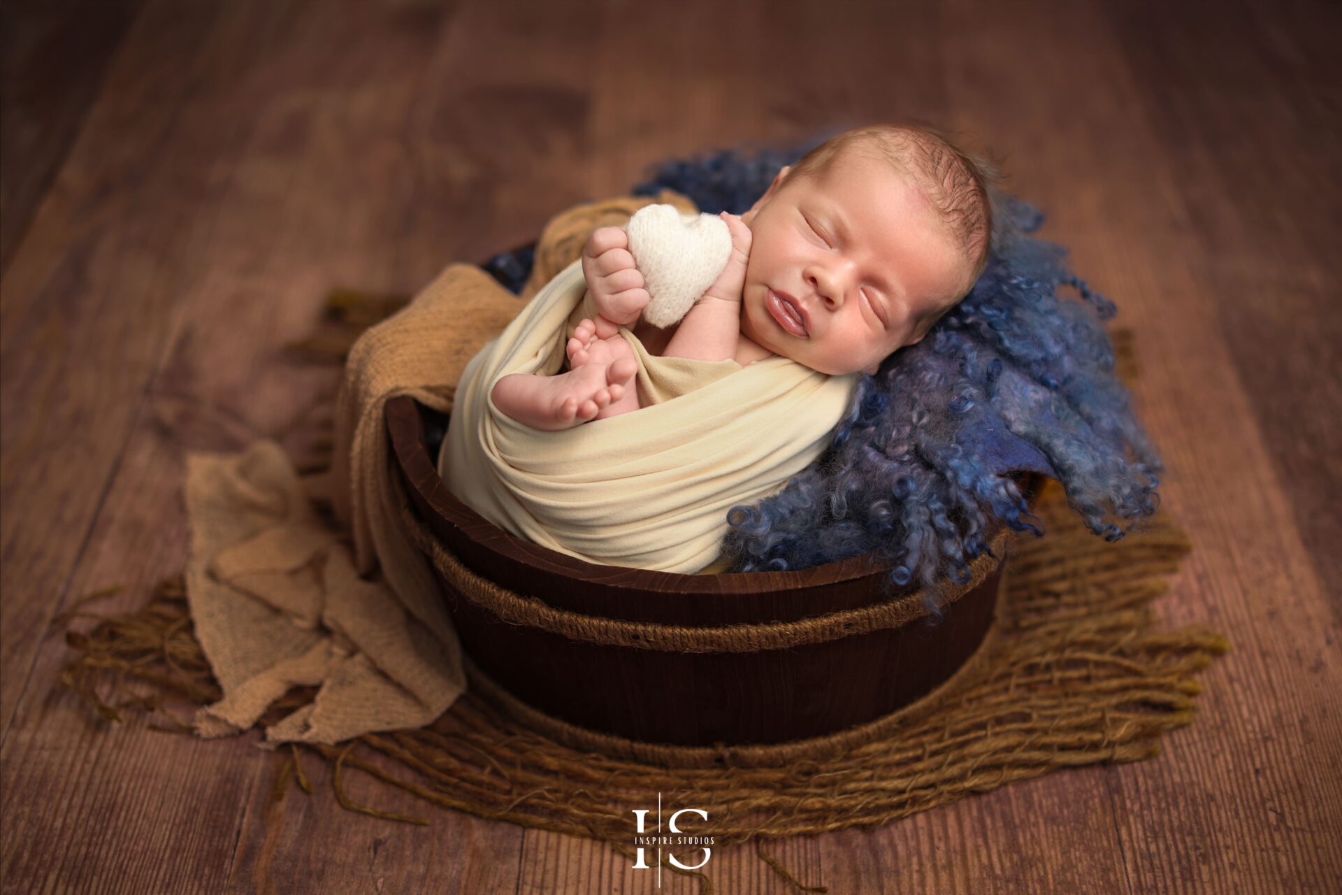 Newborn studio session in London with baby boy styled in boho cream setup