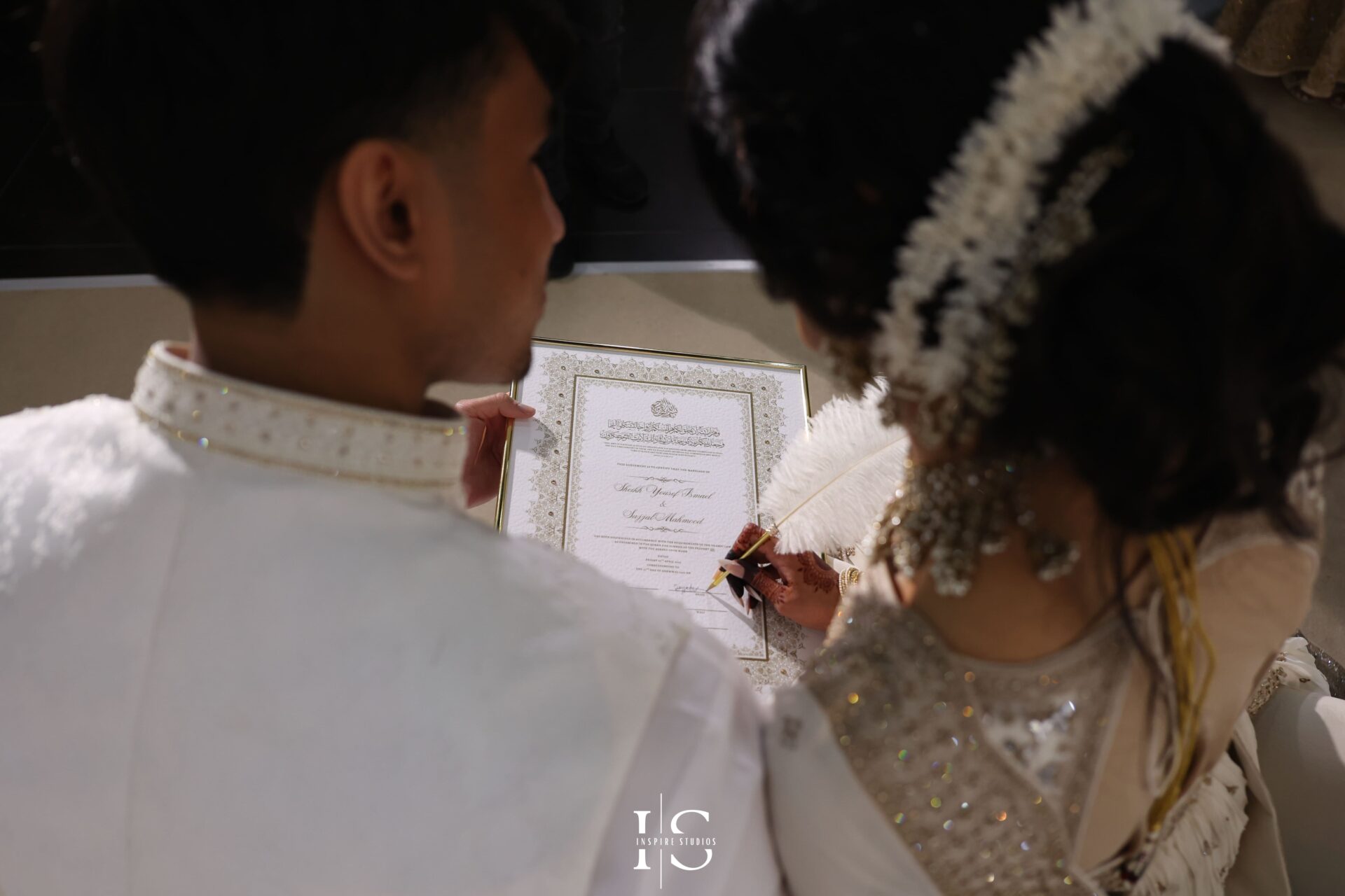 Bride and groom signing Nikkah contract – Islamic wedding moment