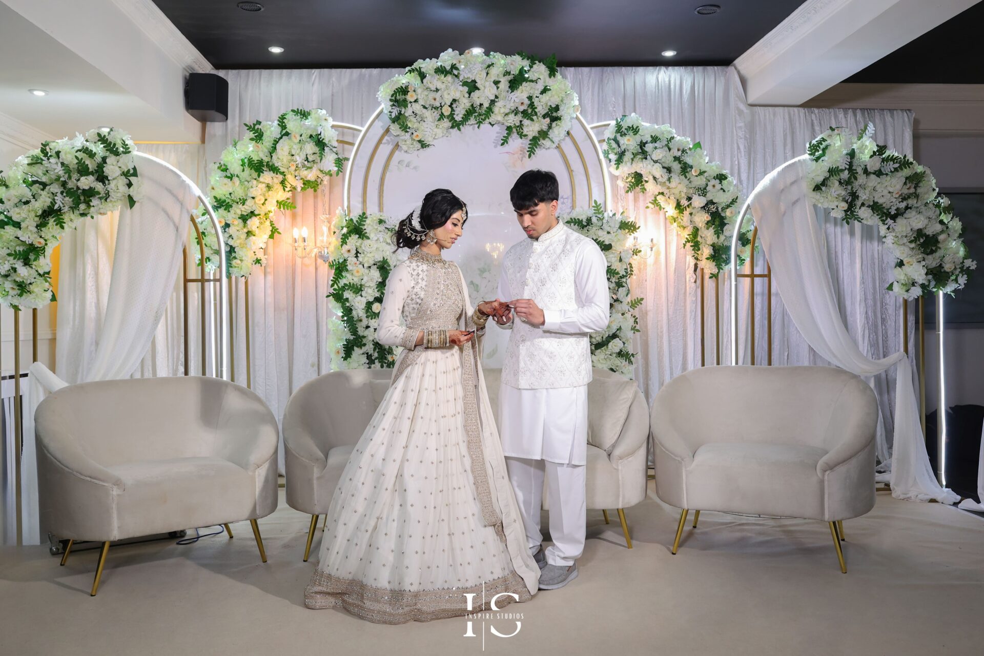 Bride and groom ring exchange on stage – Crown Banqueting Ilford