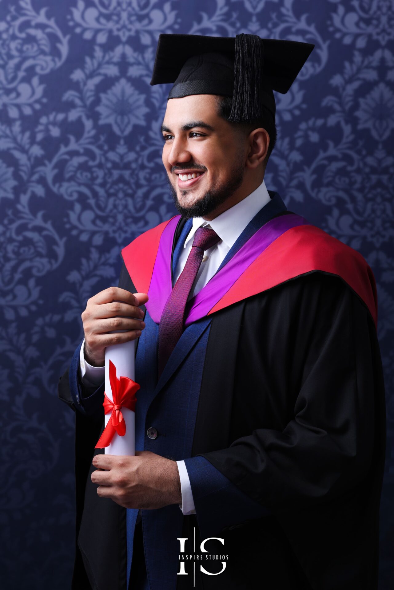 Close family portrait during graduation studio photoshoot, smiling and proud