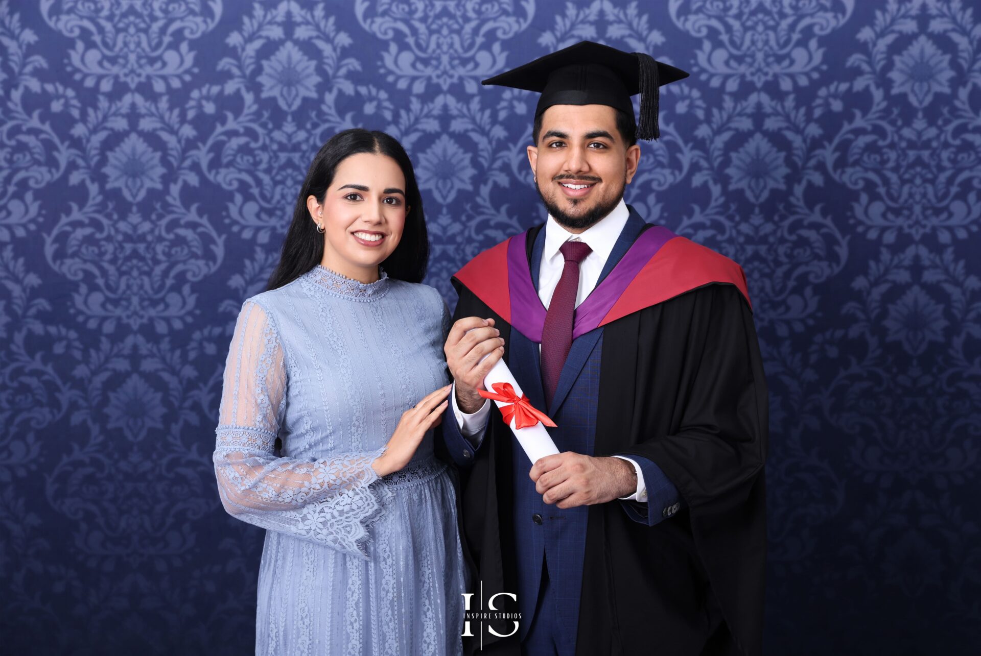 Graduation family posing together in studio with smiles and caps