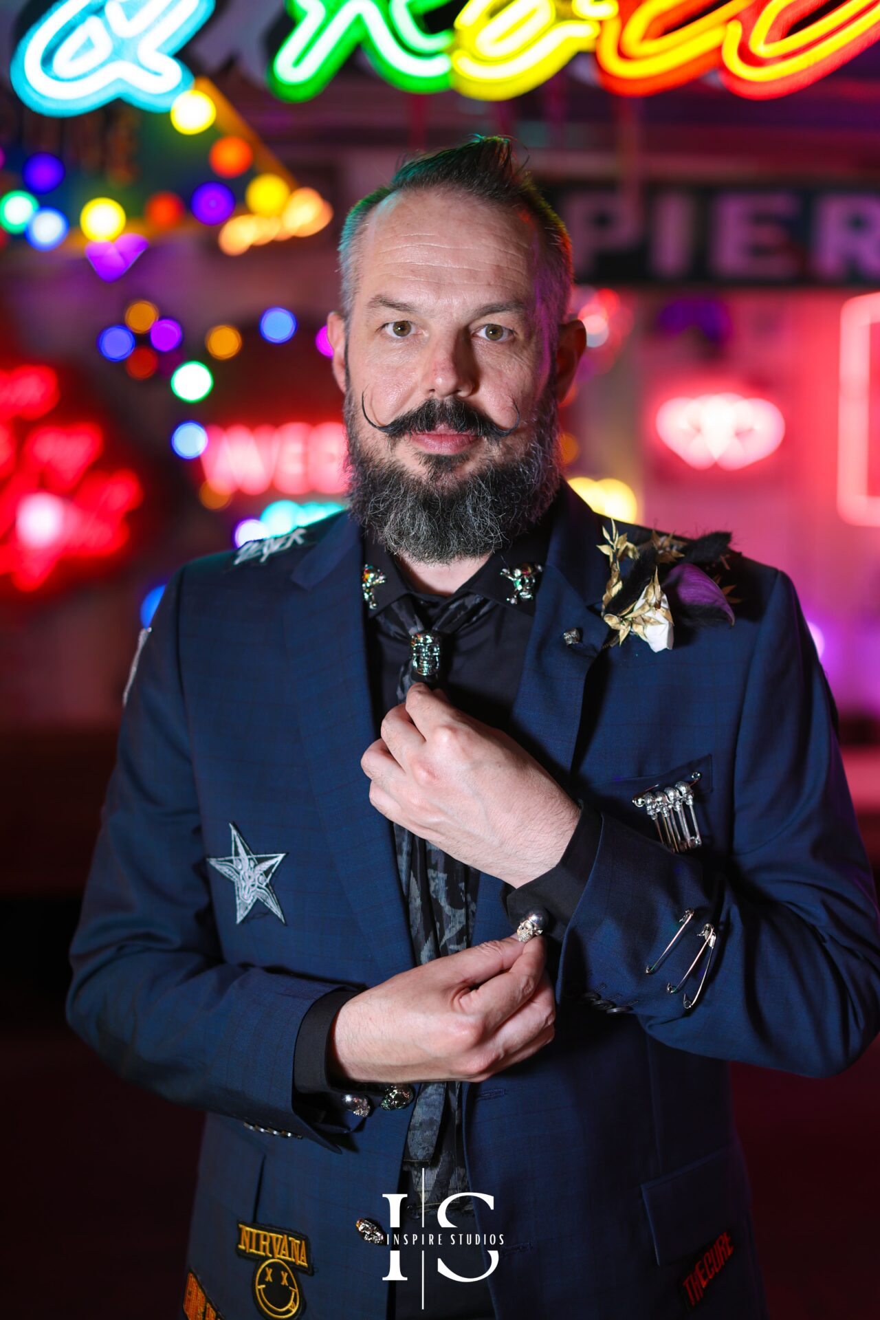 Detailed close-up shots of groom getting ready at Gods Own Junkyard punk wedding
