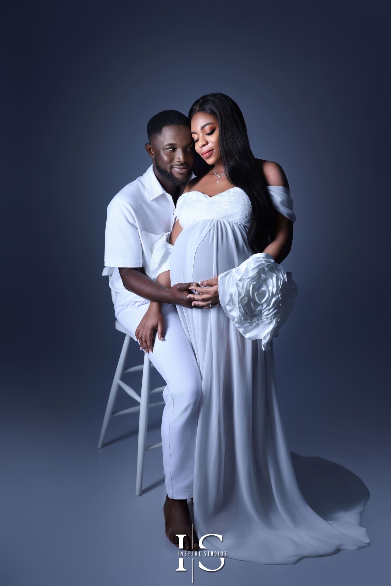 Maternity couple posing together in a London studio during a maternity photoshoot