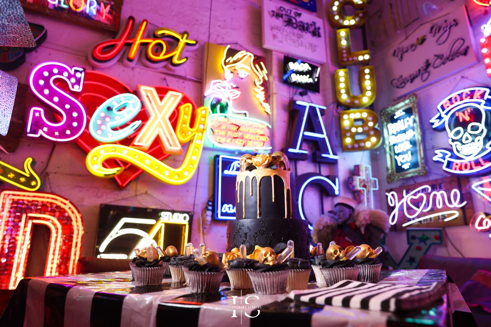 Punk wedding cake illuminated by neon lights at Gods Own Junkyard Walthamstow