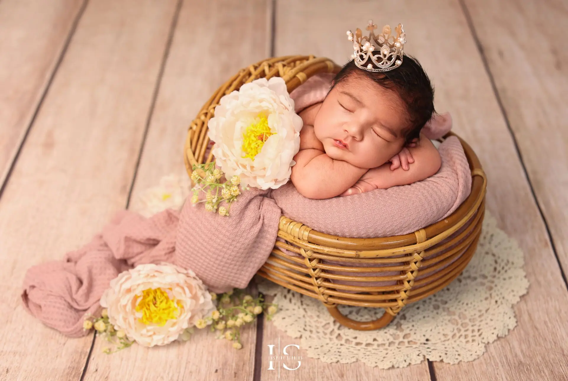 London-based newborn photographer captures baby girl in floral wrap.