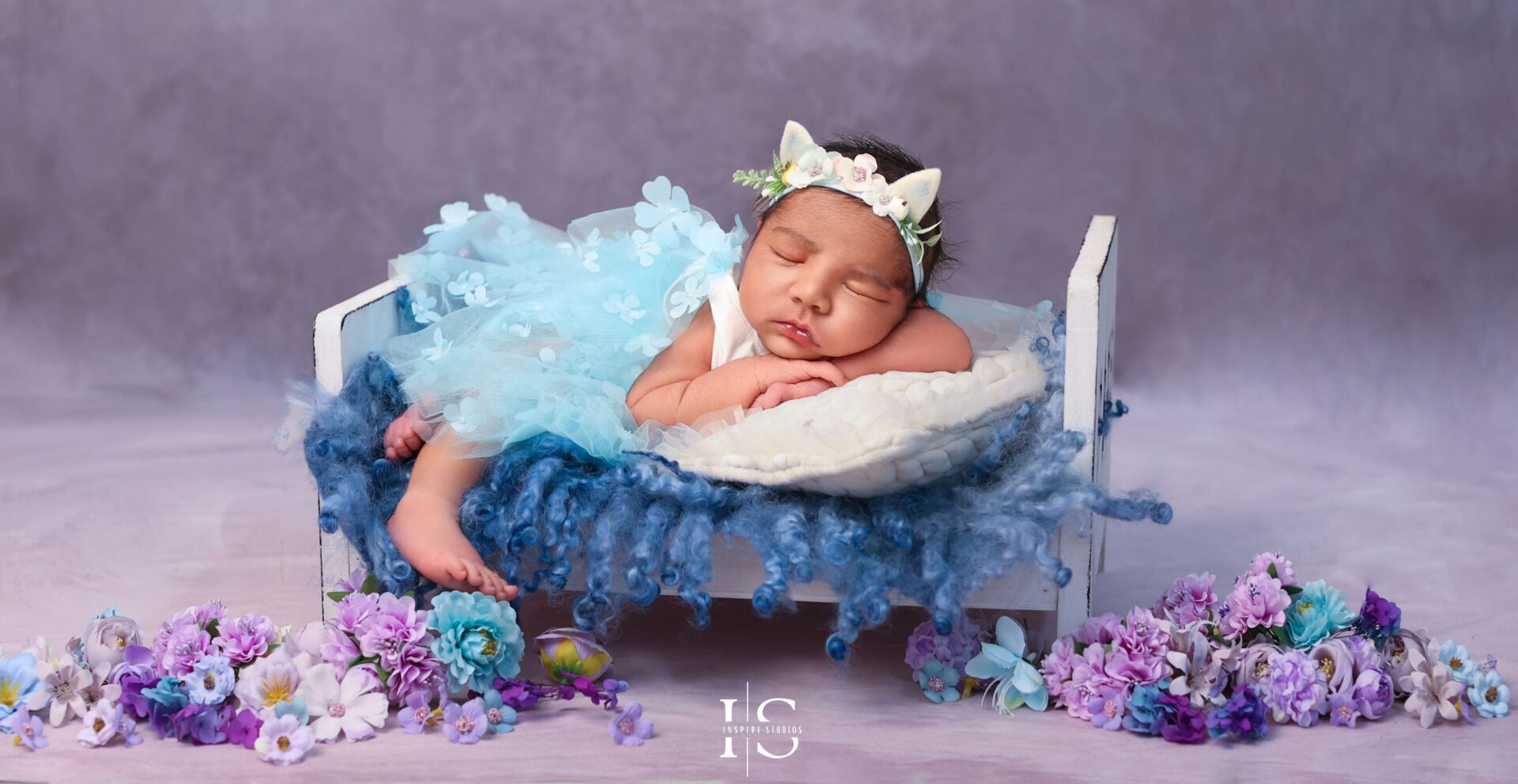 Family holding their newborn during a London studio photoshoot.