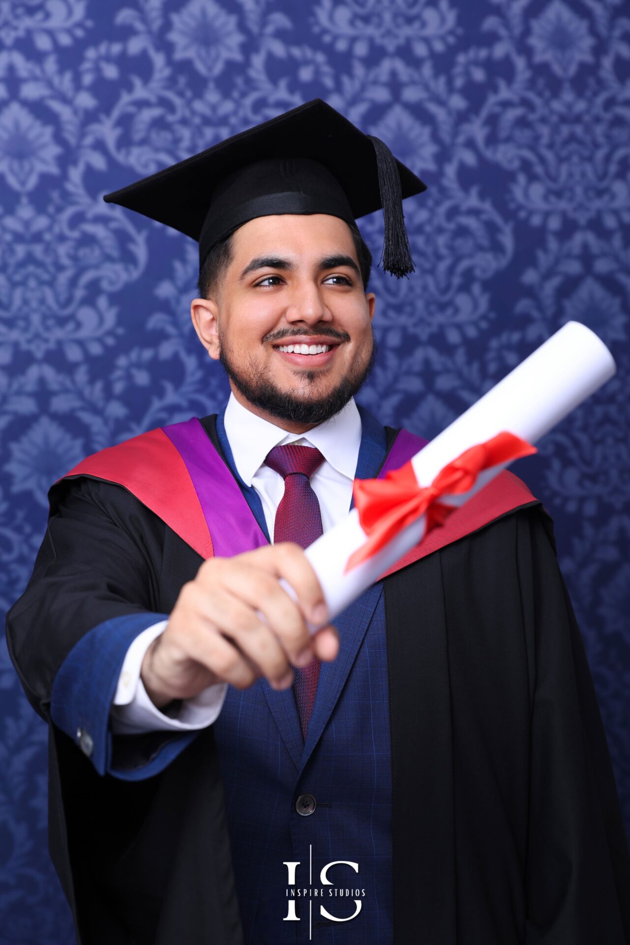 University graduate posing in London studio for graduation photoshoot