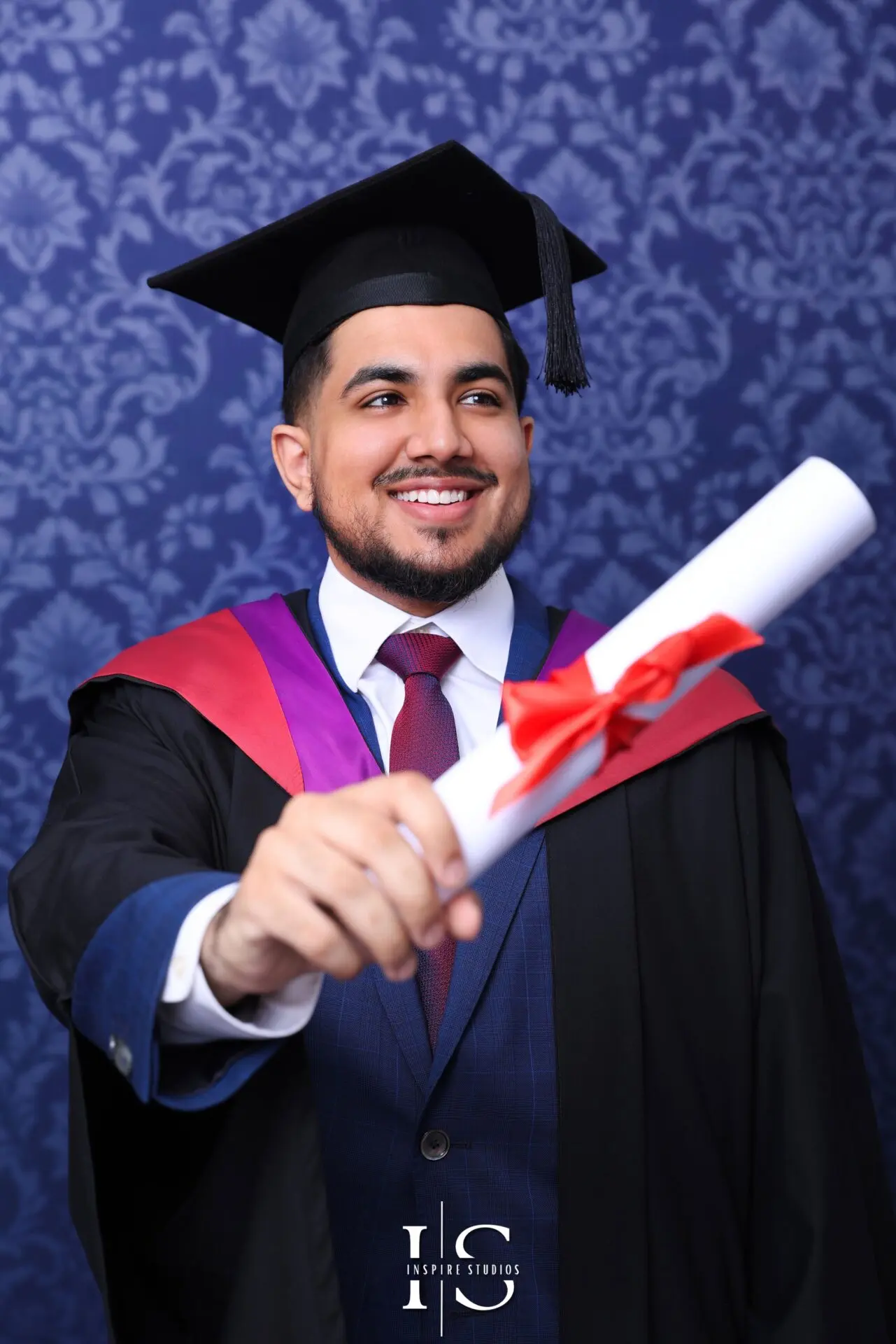 University graduate posing in London studio for graduation photoshoot