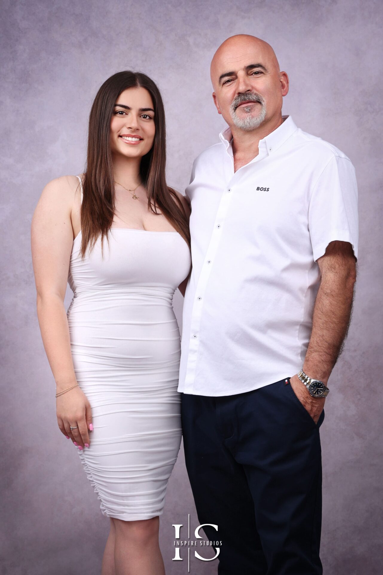 Albanian couple celebrating 25th wedding anniversary with family in studio