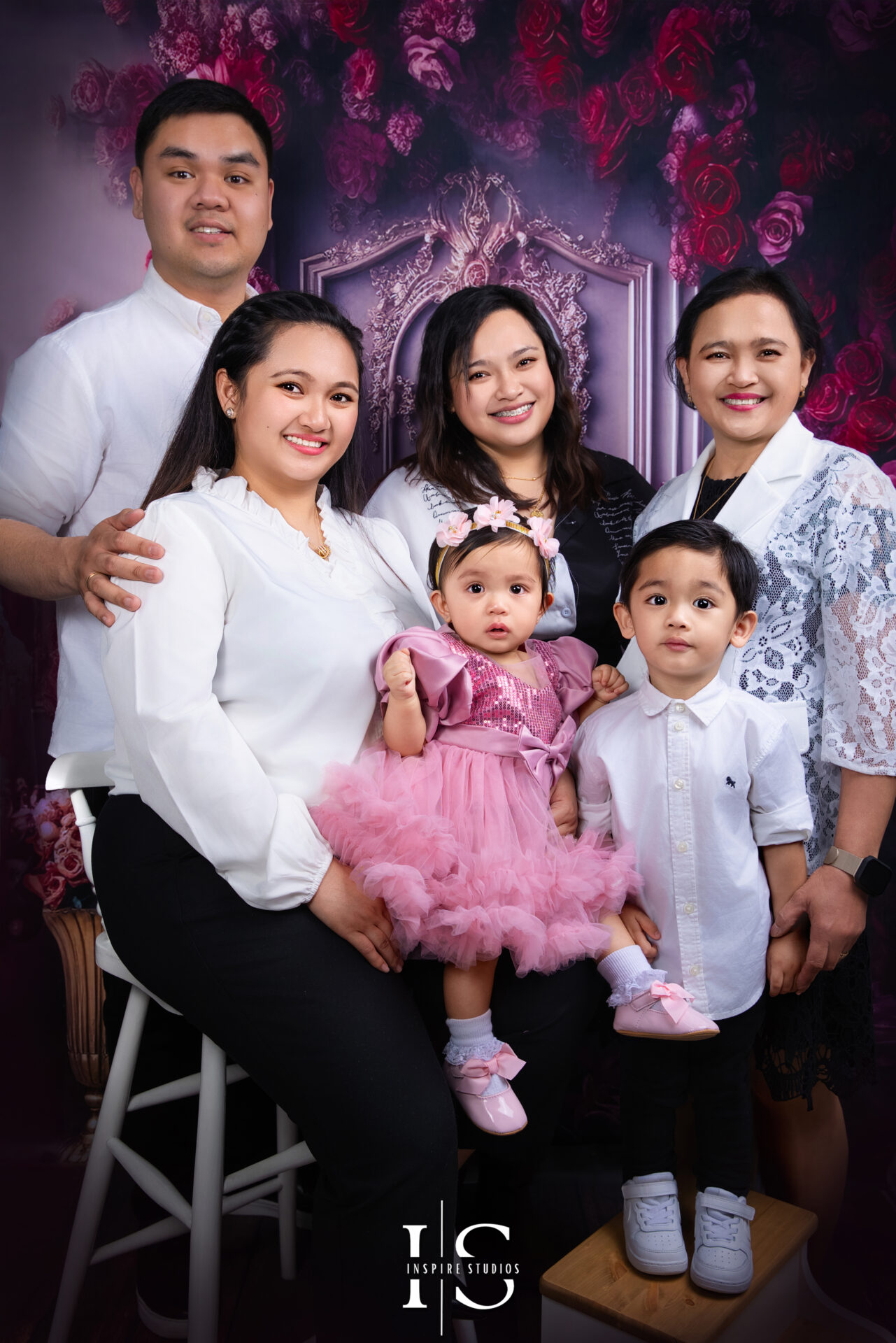 Family celebrating first birthday with toddler during a studio photoshoot