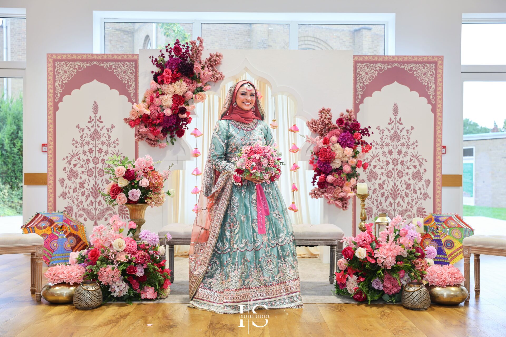 Bangladeshi bride on Mehndi stage during London wedding.