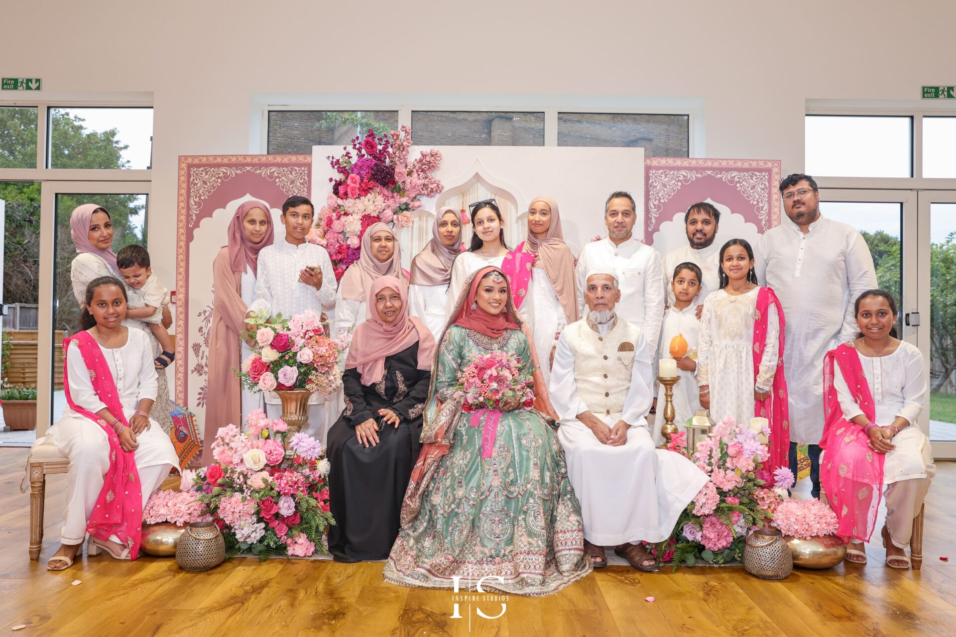 Bride celebrating with guests during Mehndi in London.