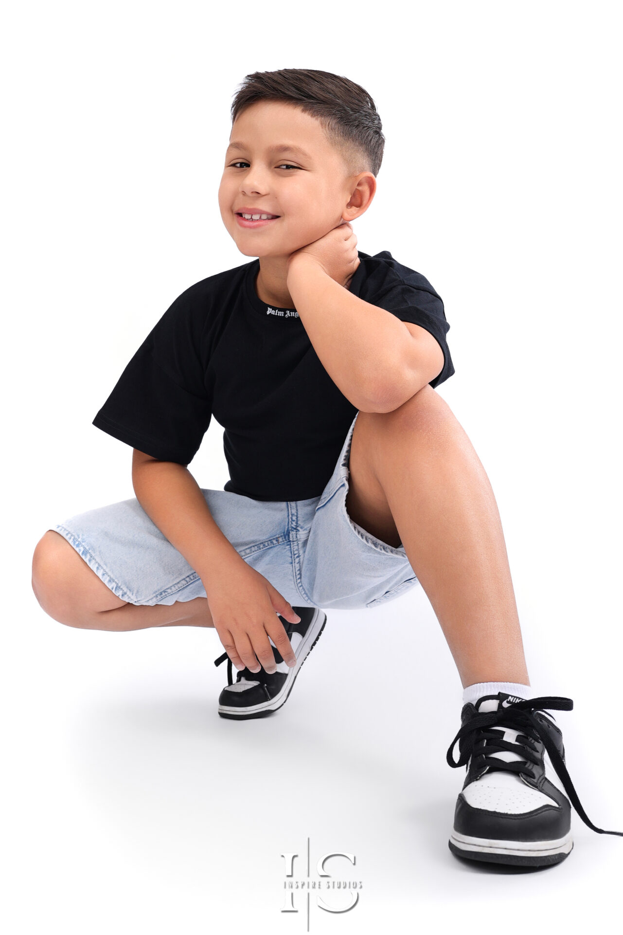 Child posing for a creative headshot session with natural expressions.