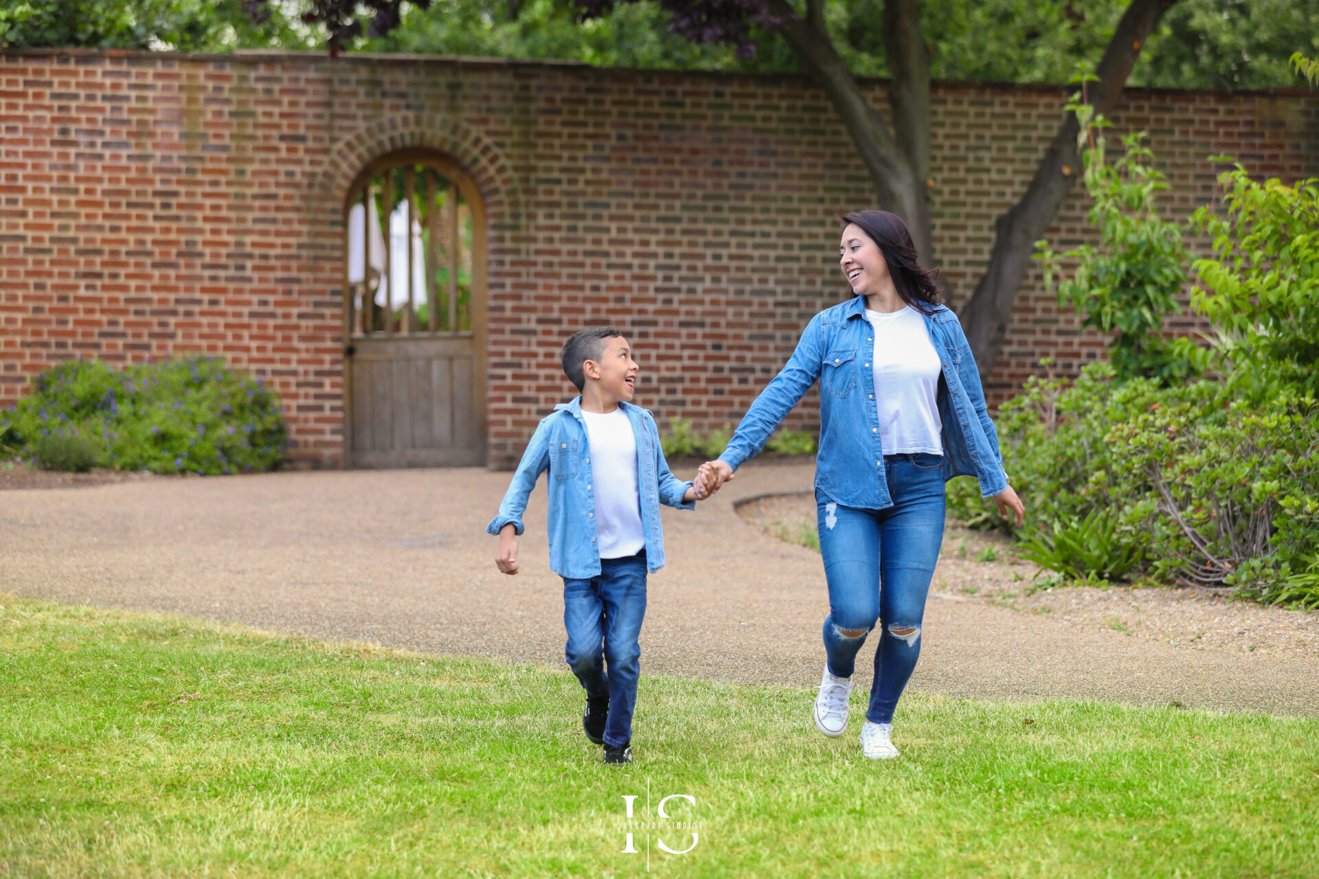 Family enjoying a professional park session in London with relaxed poses and smiles.