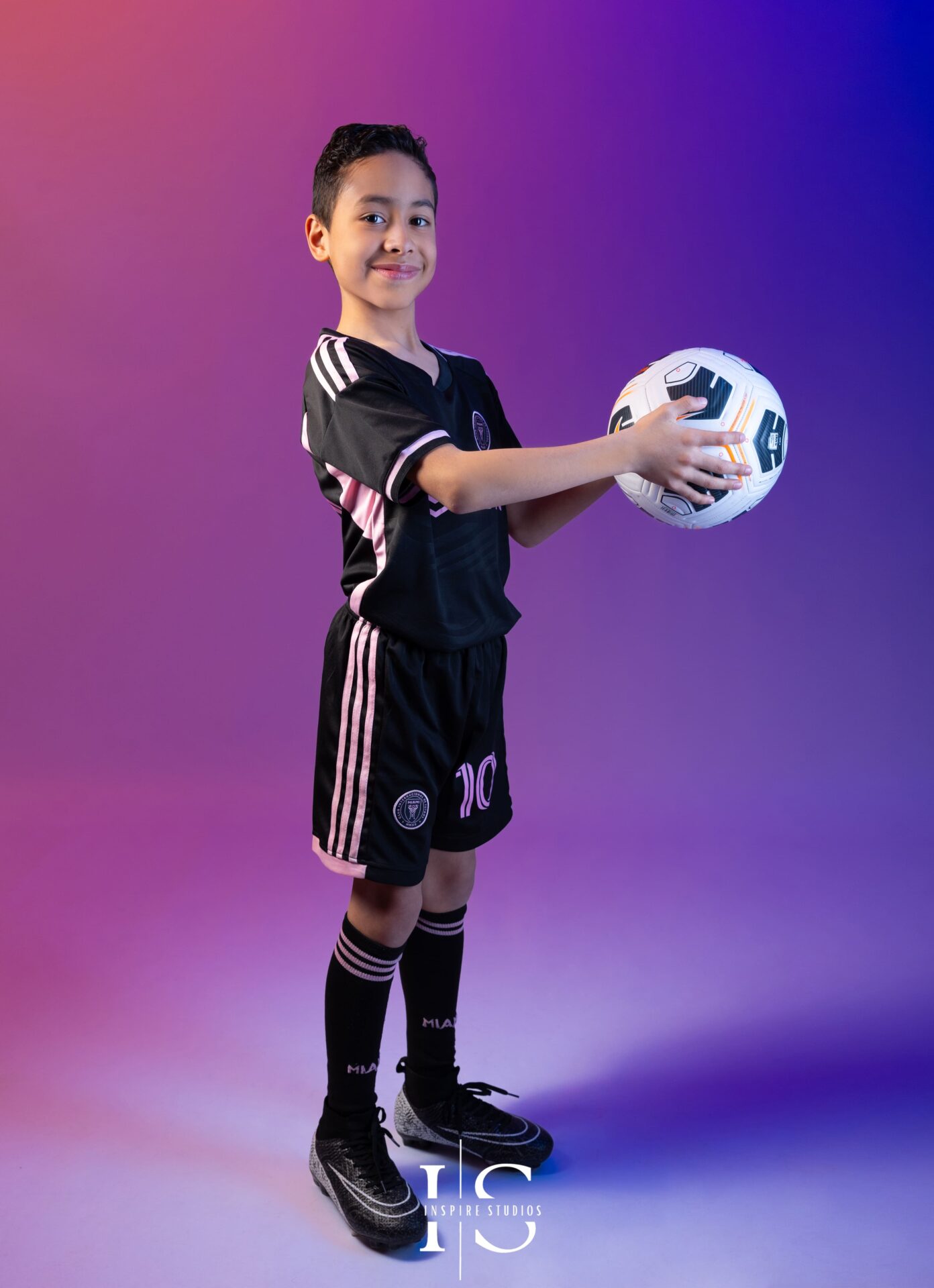 Child in football themed studio photoshoot London