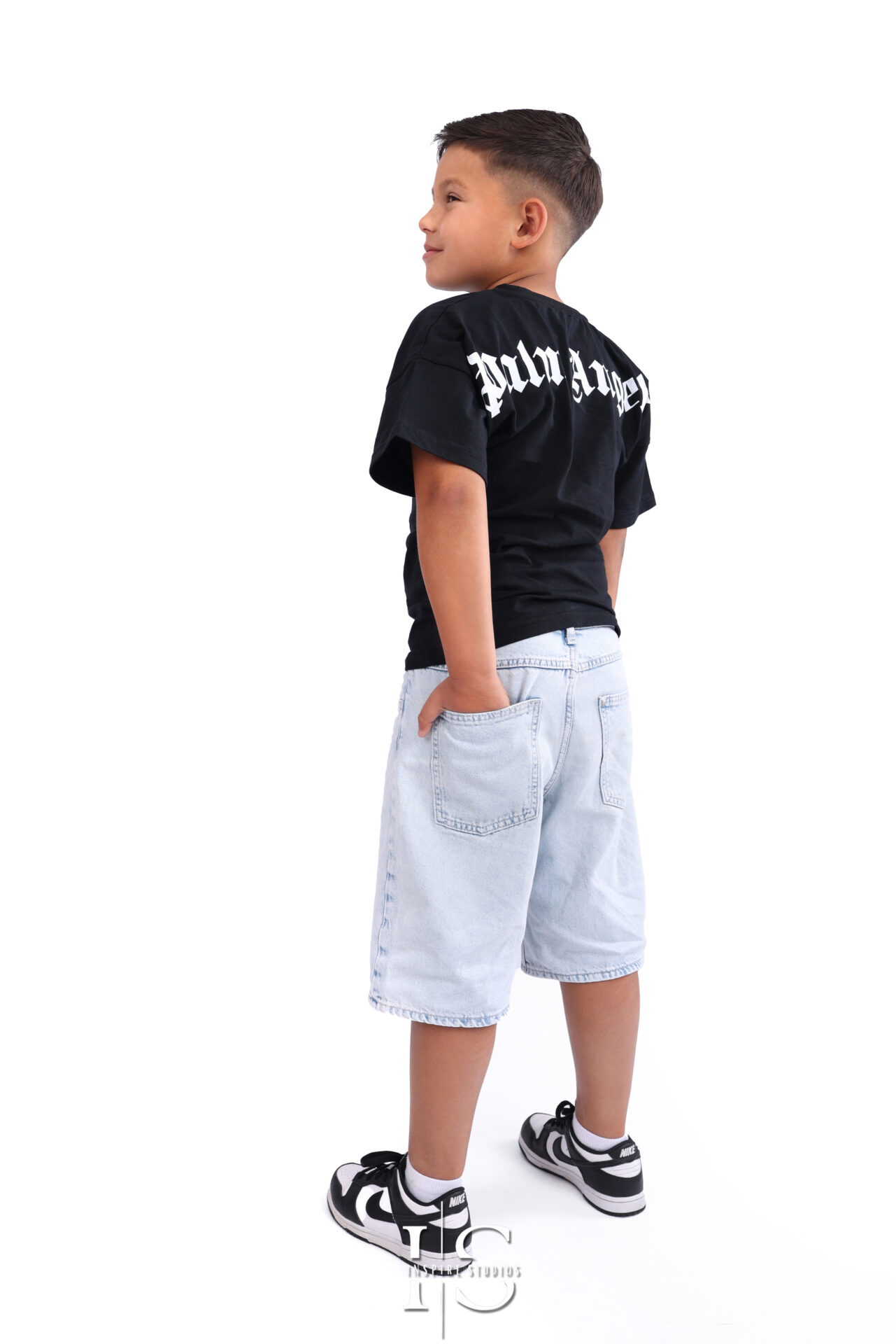 Smiling child during professional headshot studio shoot.