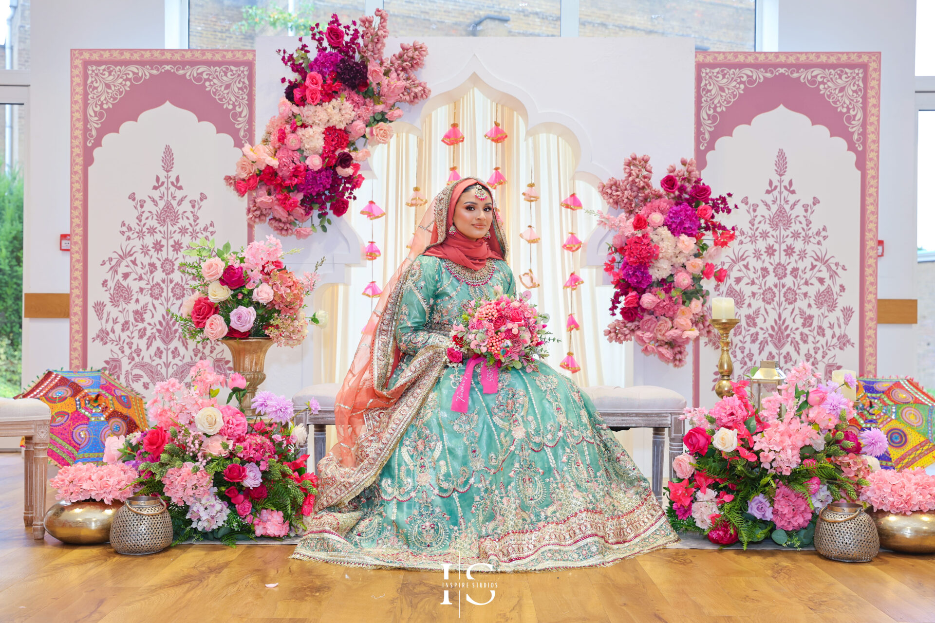 Mehndi bride posing at wedding stage in London.