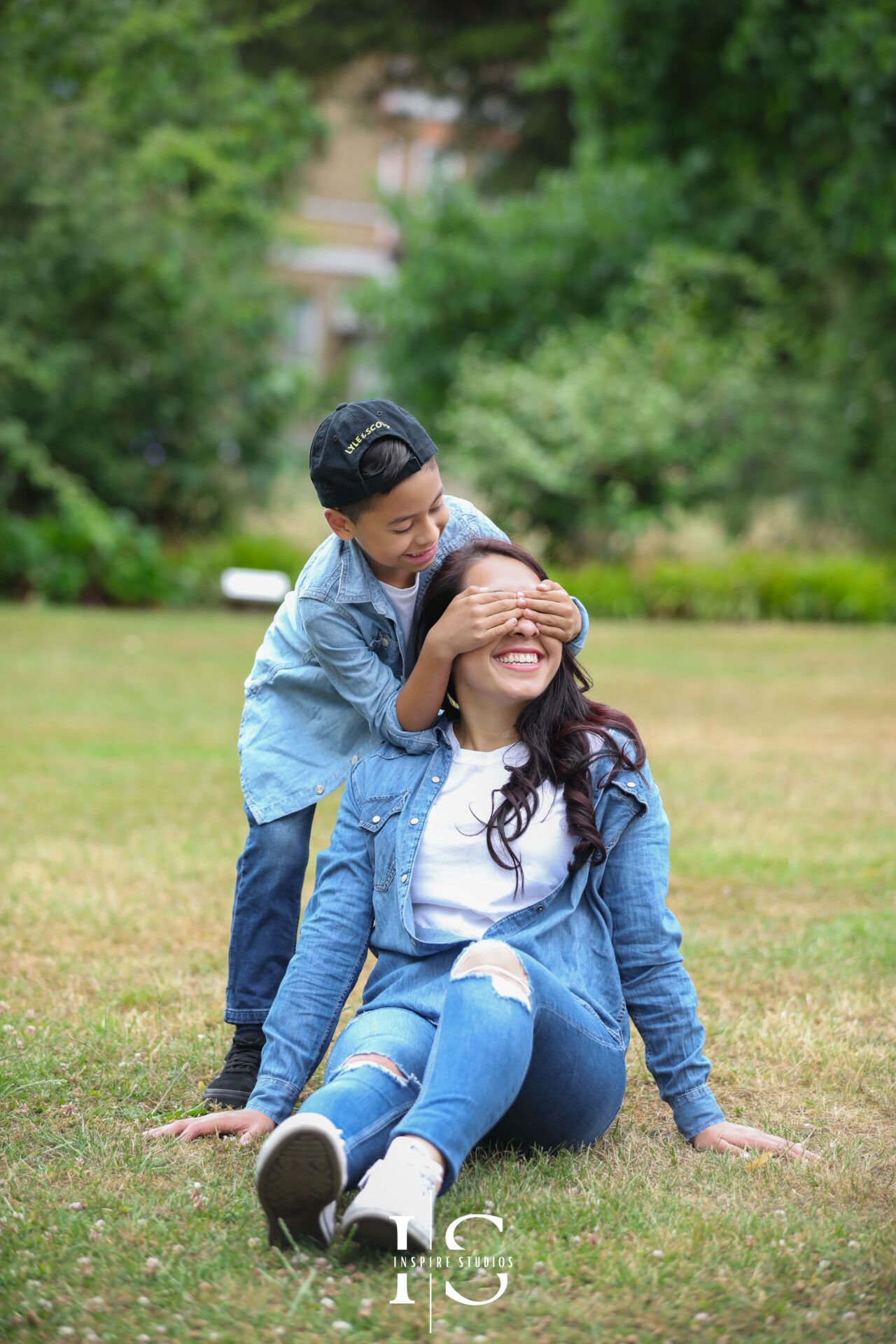 Mother and son sharing a natural moment captured during an outdoor photoshoot.