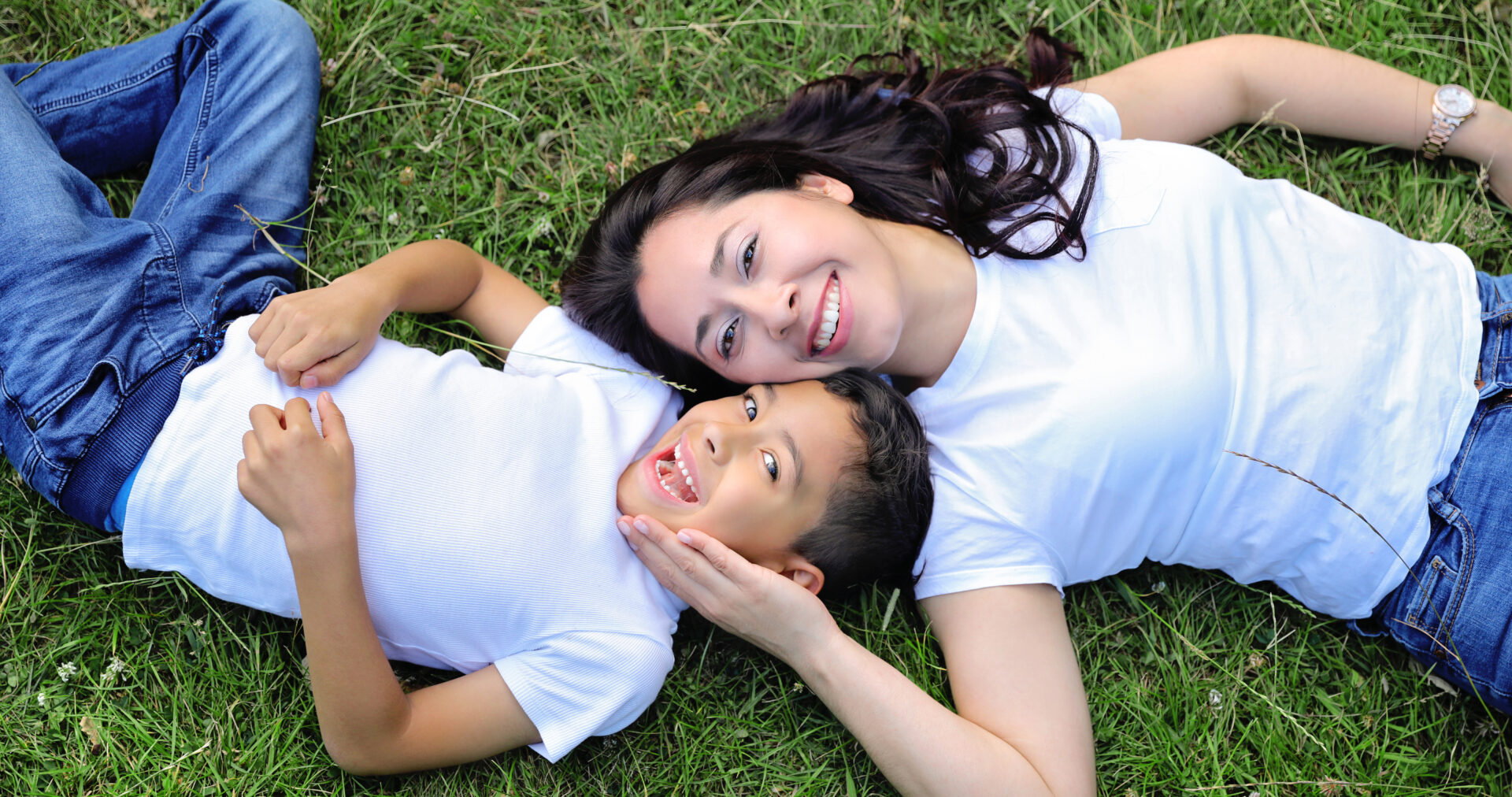 Happy family posing for outdoor family photography in a scenic London park.