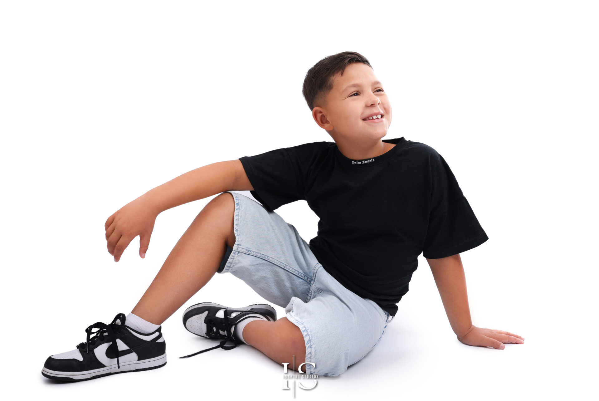 Studio children’s headshot showing playful and candid expression.
