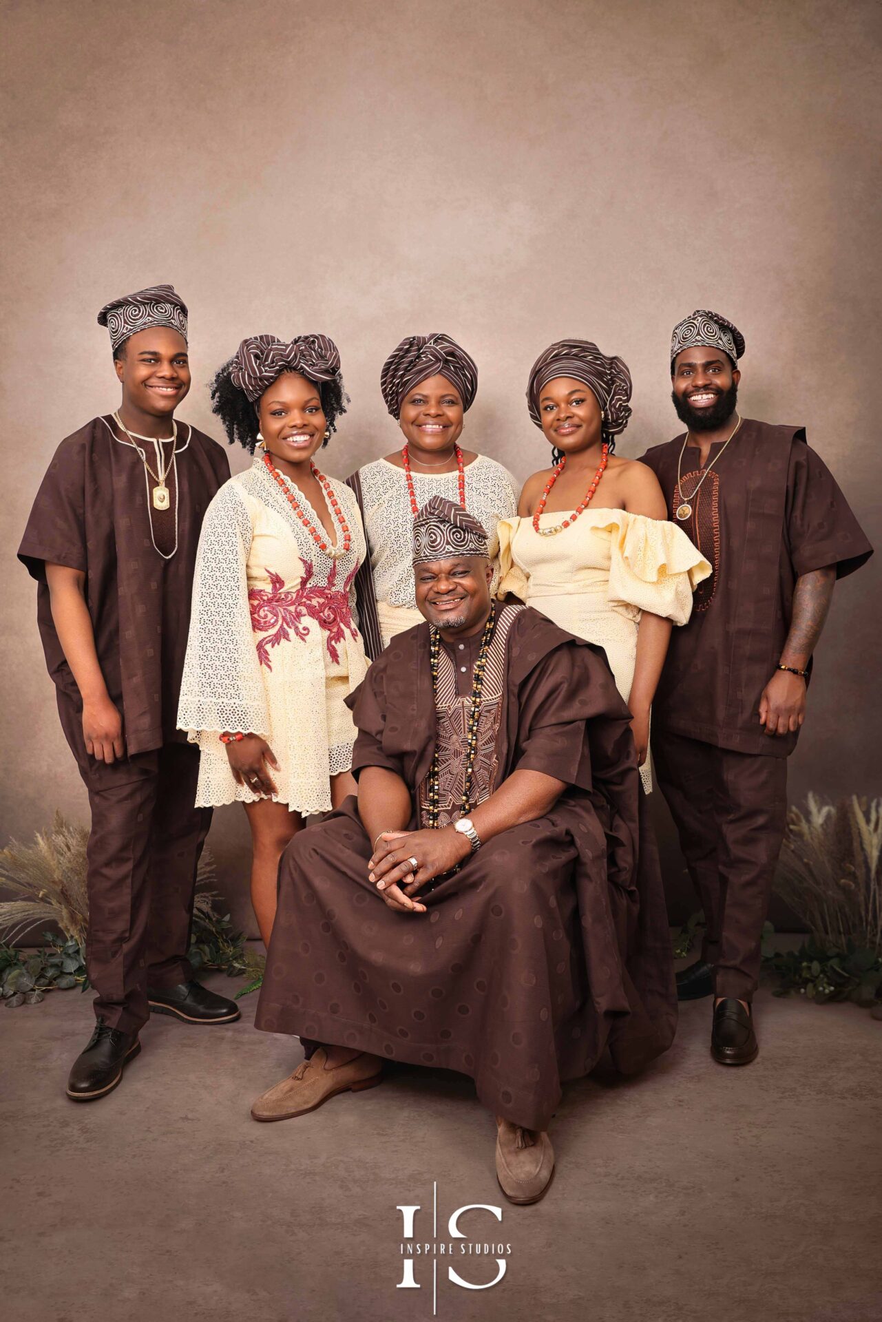 African family enjoying a professional studio photoshoot with joyful poses and vibrant outfits