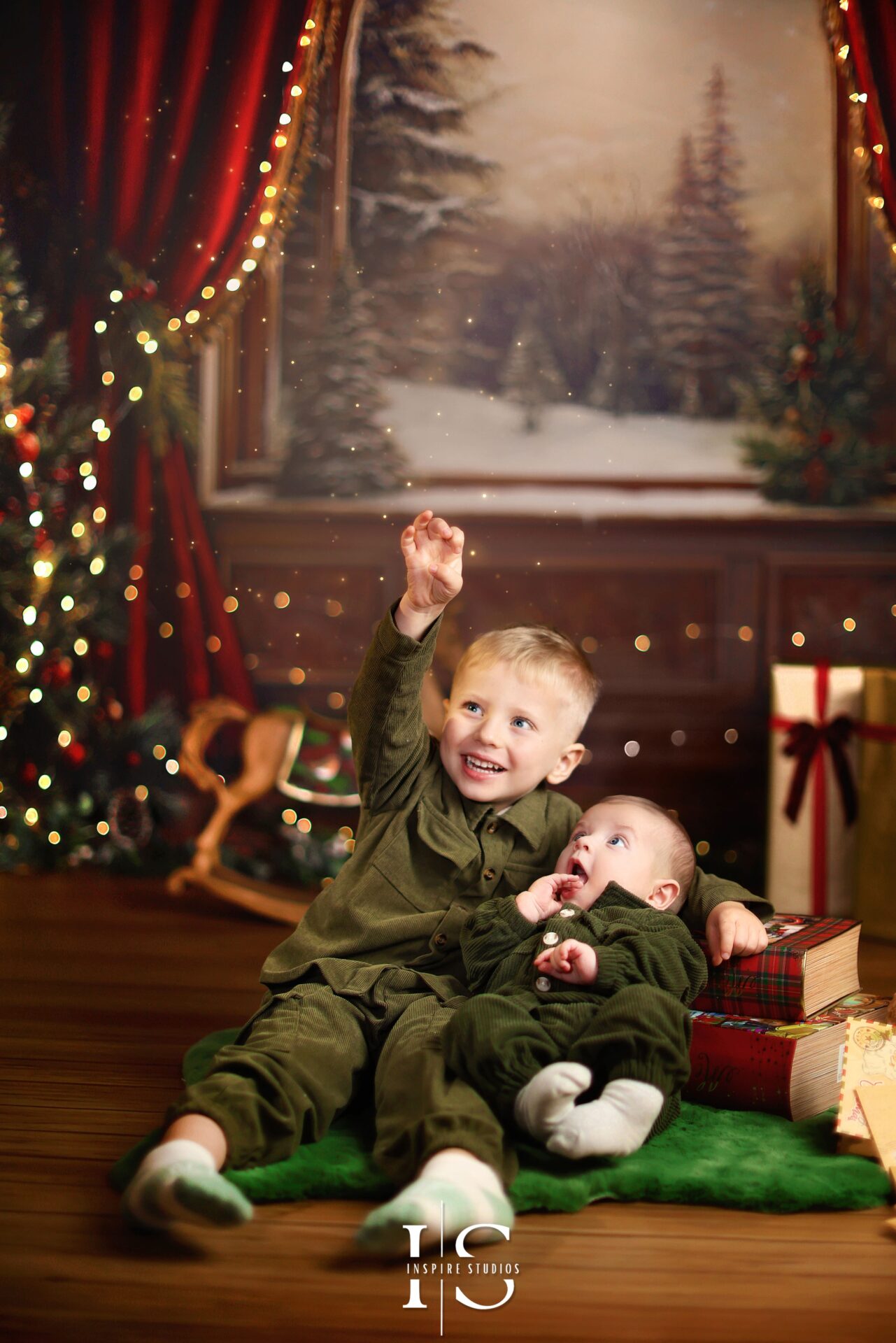 Boy smiling during Christmas family photoshoot in London 2025 against Inspire Studios festive Christmas backdrop