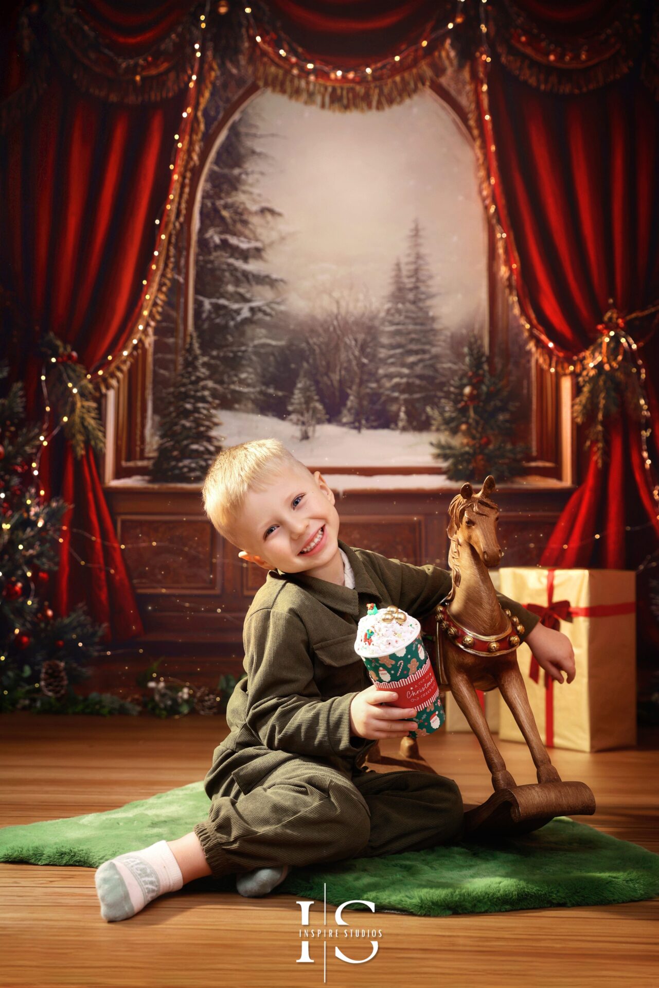 Young boy posing for Christmas photoshoot in E17 at Inspire Studios festive backdrop