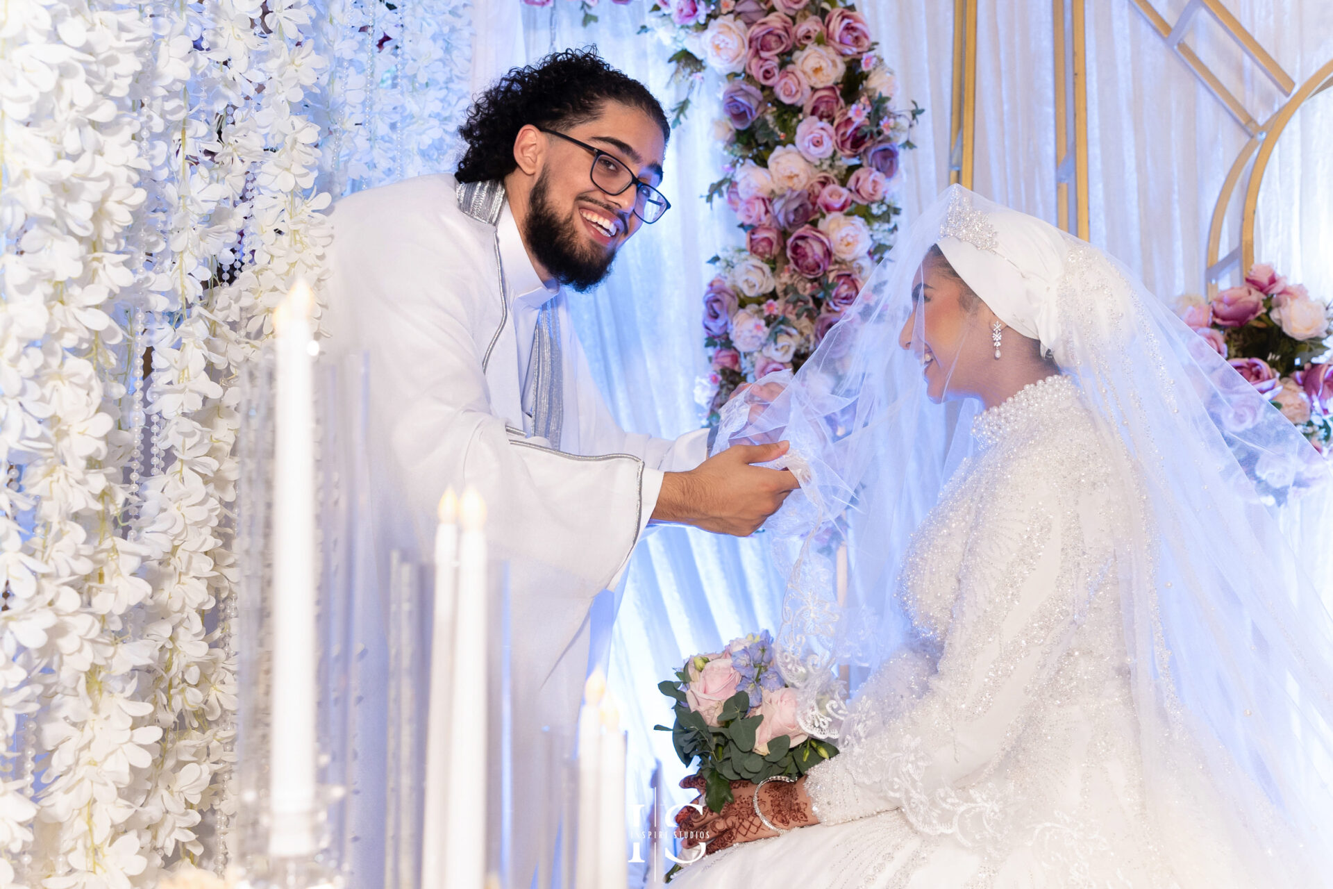Groom lifting bride’s veil during Nikkah ceremony at Pavilion Banqueting Walthamstow, London – captured by Inspire Studios