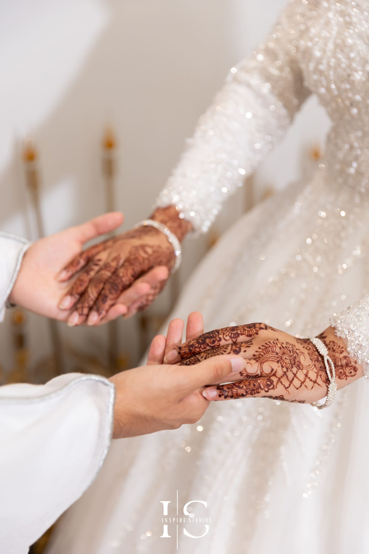 Bride and groom holding hands during Nikkah wedding at Pavilion Banqueting Walthamstow, London – captured by Inspire Studios