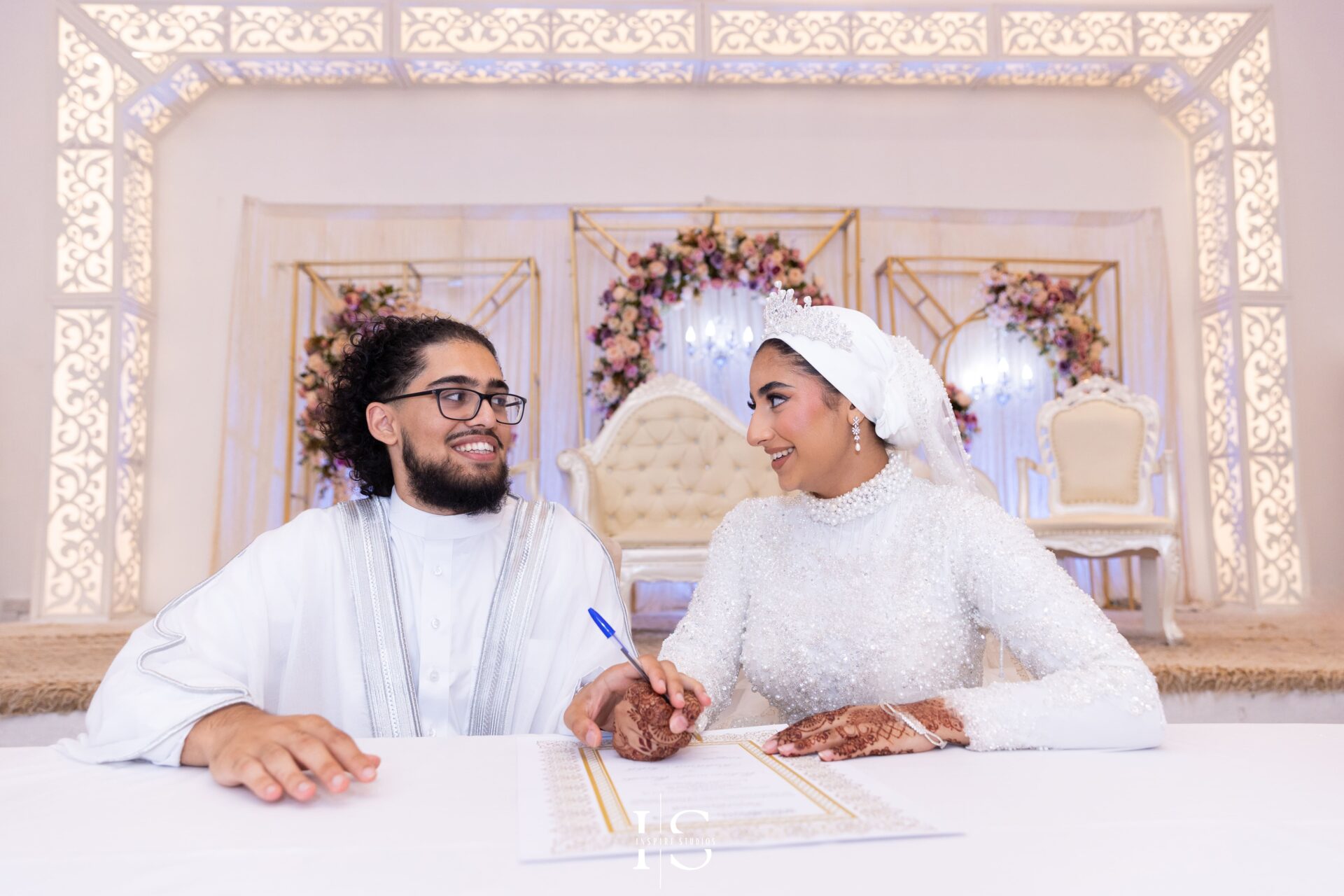 Bride and groom signing Nikkah contract at Pavilion Banqueting Walthamstow, London – captured by Inspire Studios