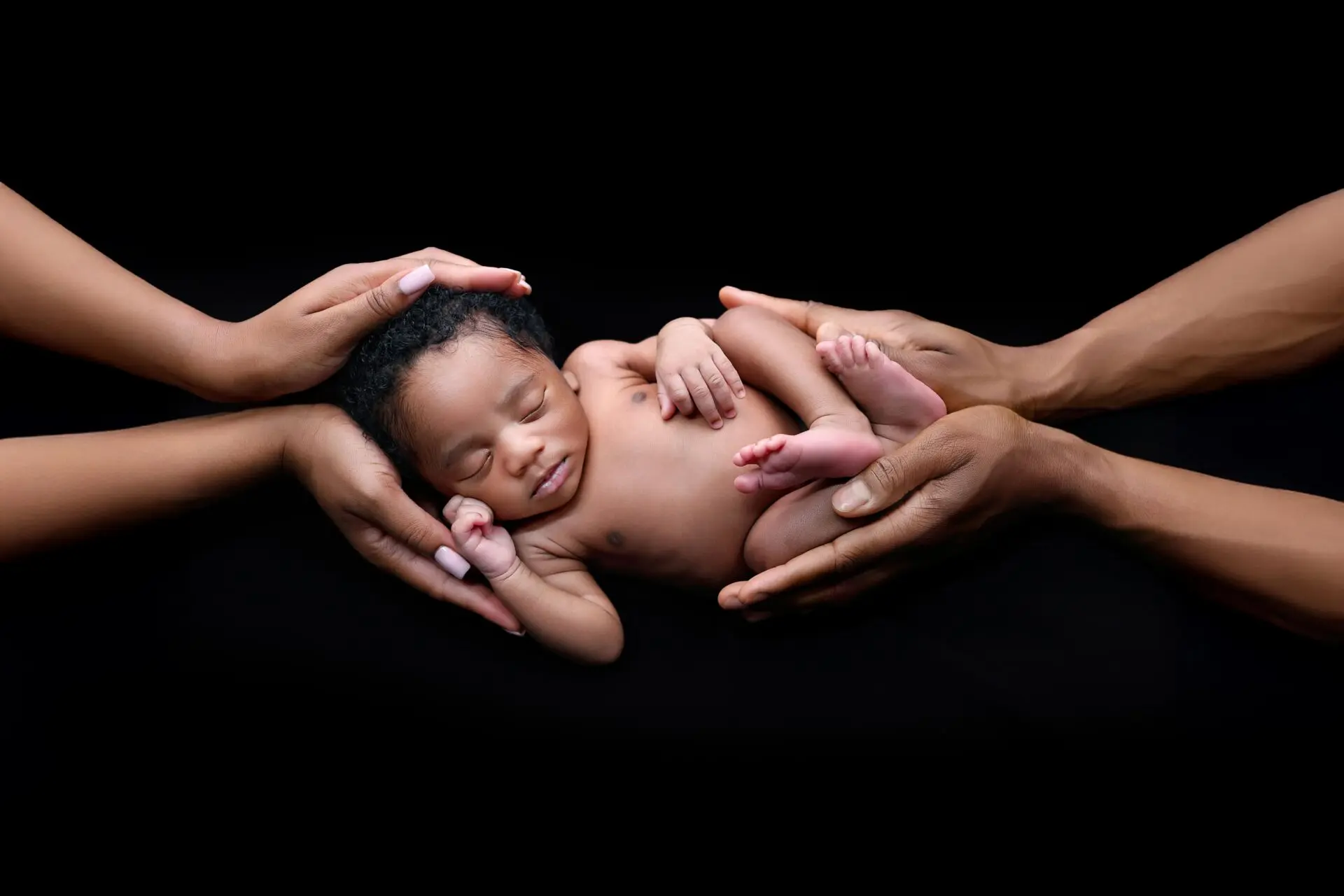 Newborn and parent hands holding during photoshoot in London – emotional newborn photography ideas.