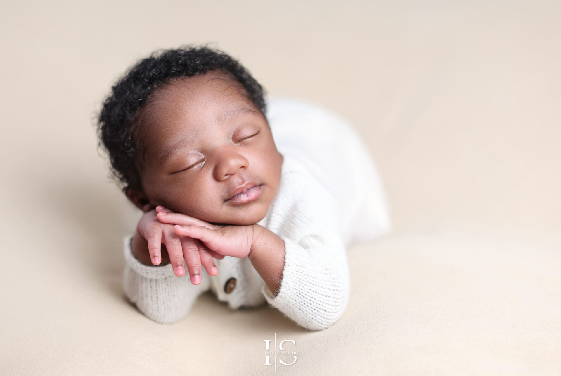 Newborn posing on beanbag setup at Inspire Studios, Walthamstow, London.