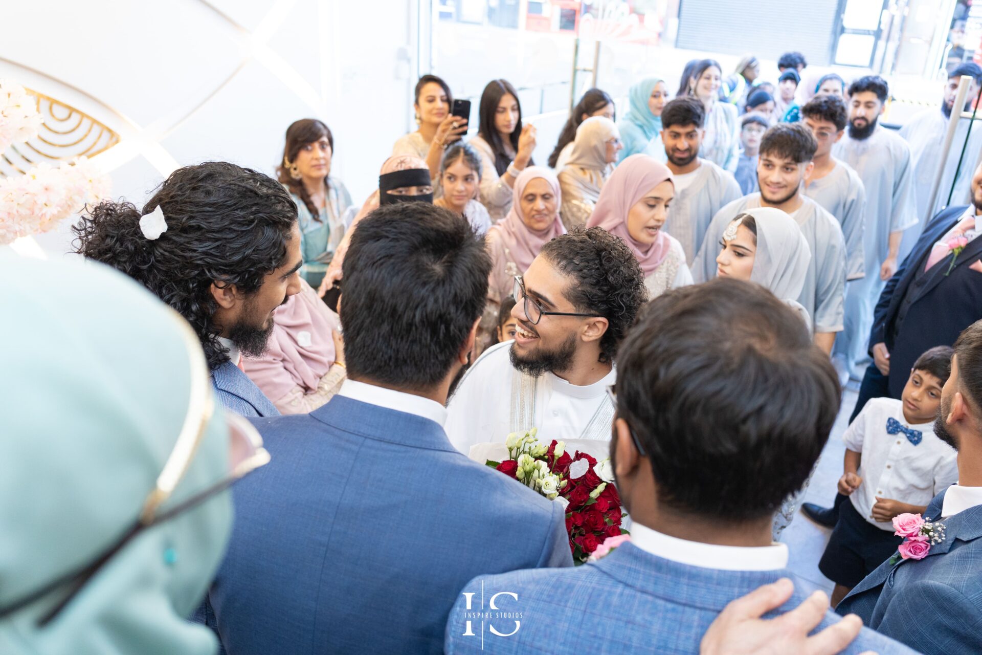 Groom surrounded by guests at Pavilion Banqueting Walthamstow, London – captured by Inspire Studios