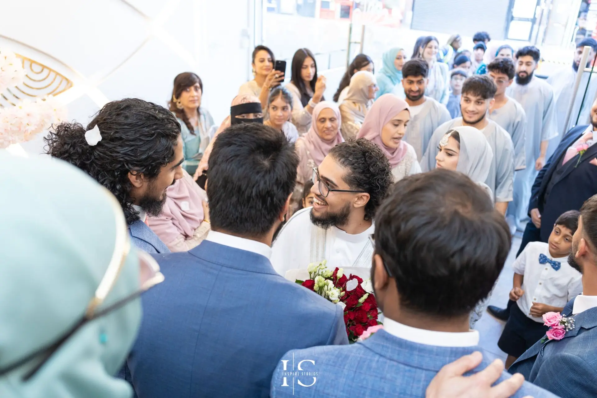 Groom surrounded by guests at Pavilion Banqueting Walthamstow, London – captured by Inspire Studios