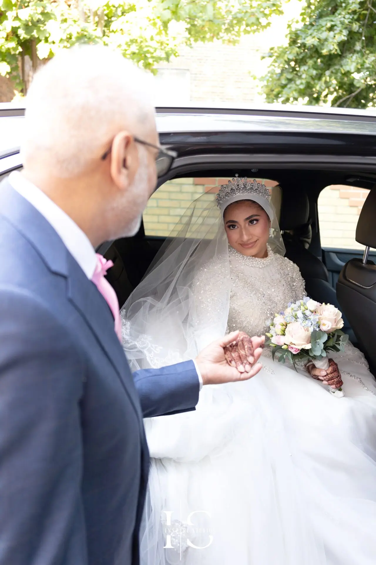 Bride arriving at Pavilion Banqueting Walthamstow, London, helped by her father – captured by Inspire Studios