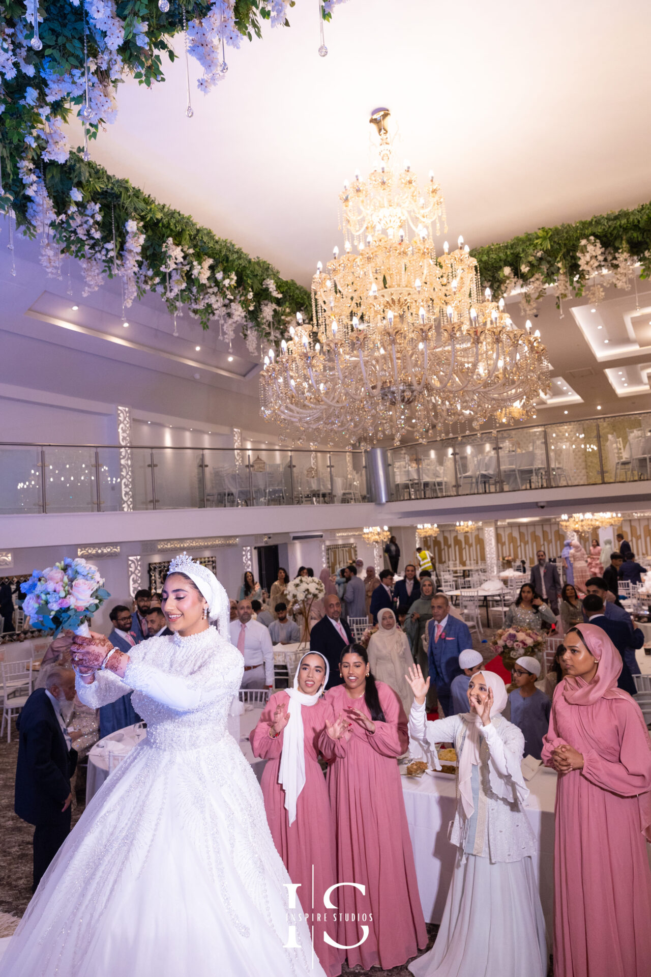 Bride throwing flower bouquet on stage at Pavilion Banqueting Walthamstow, London – captured by Inspire Studios