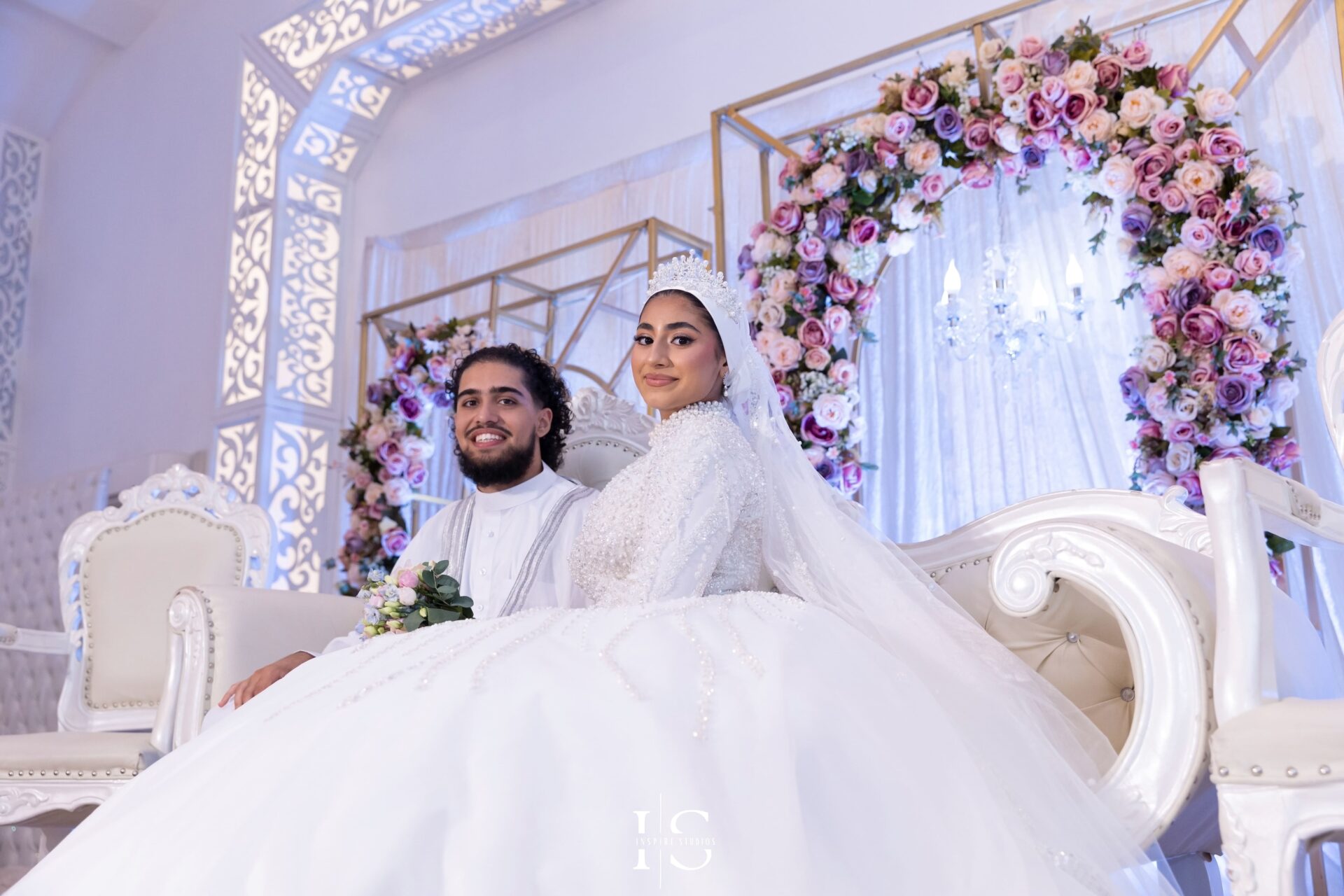 Bride and groom on the wedding stage at Pavilion Banqueting Walthamstow, London – captured by Inspire Studios